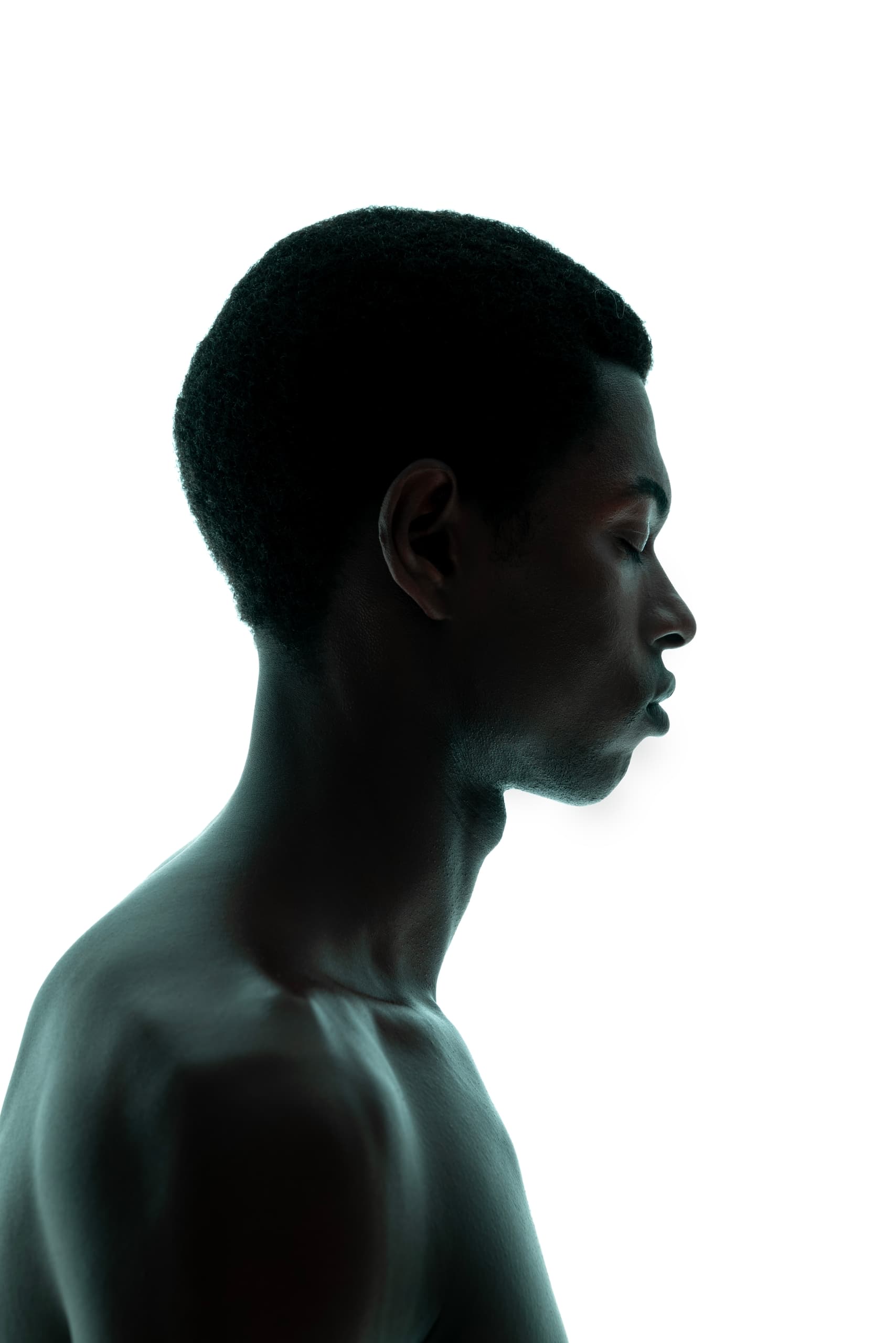 Silhouette of a serene person in profile against white background.