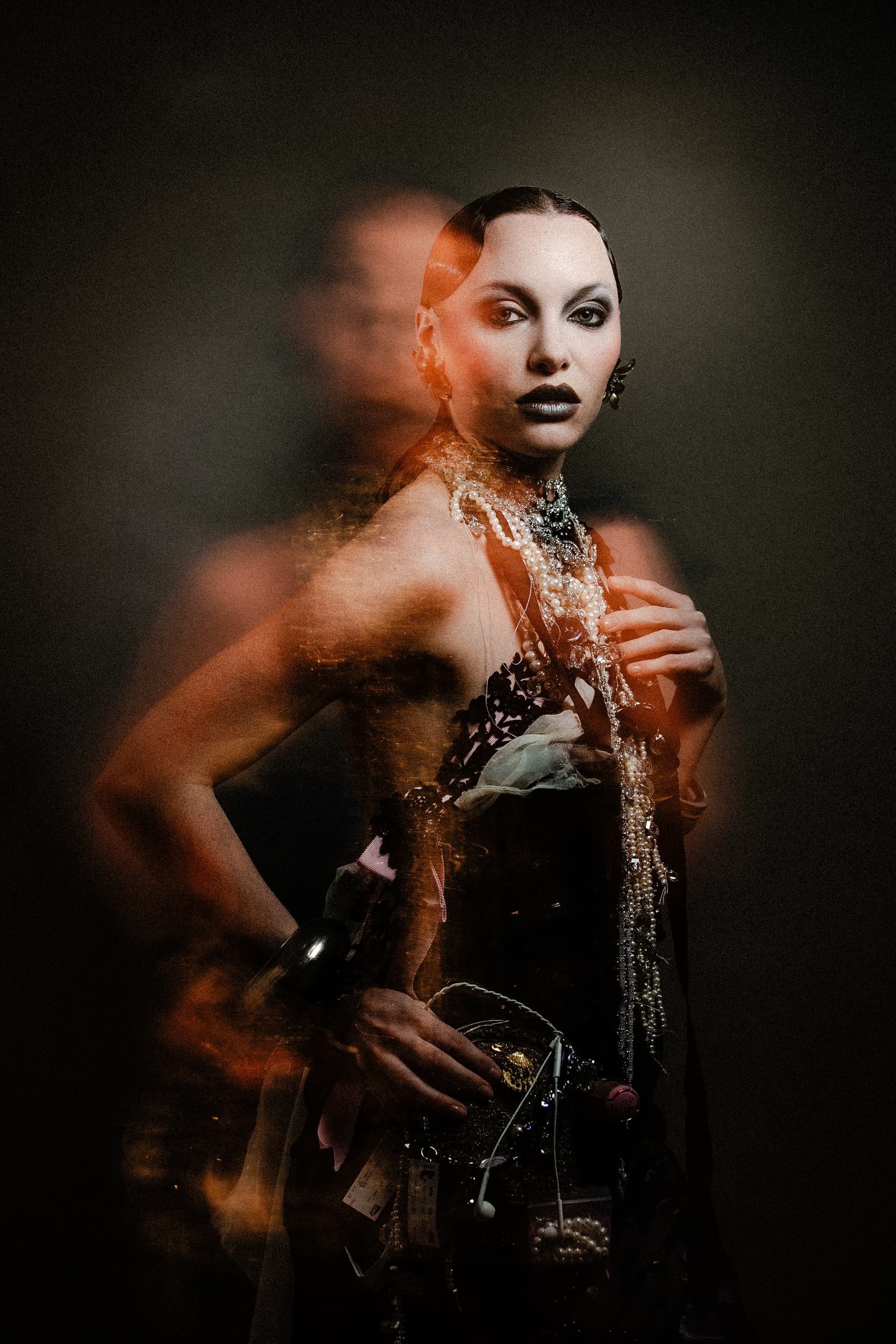 Artistic portrait of a woman in elegant attire with dramatic lighting effects.