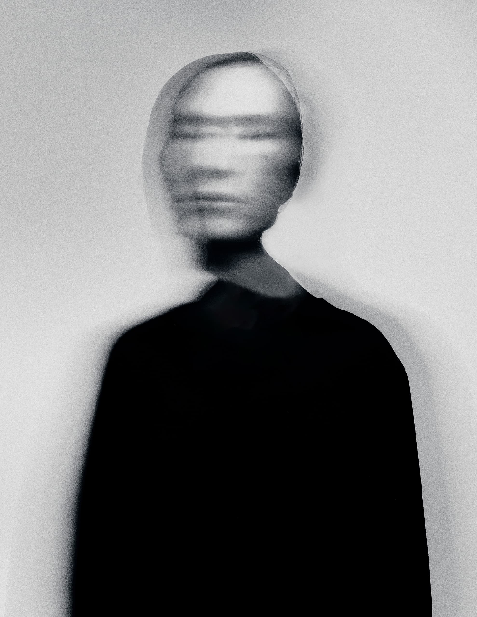 Blurred abstract portrait photography in grayscale tones.