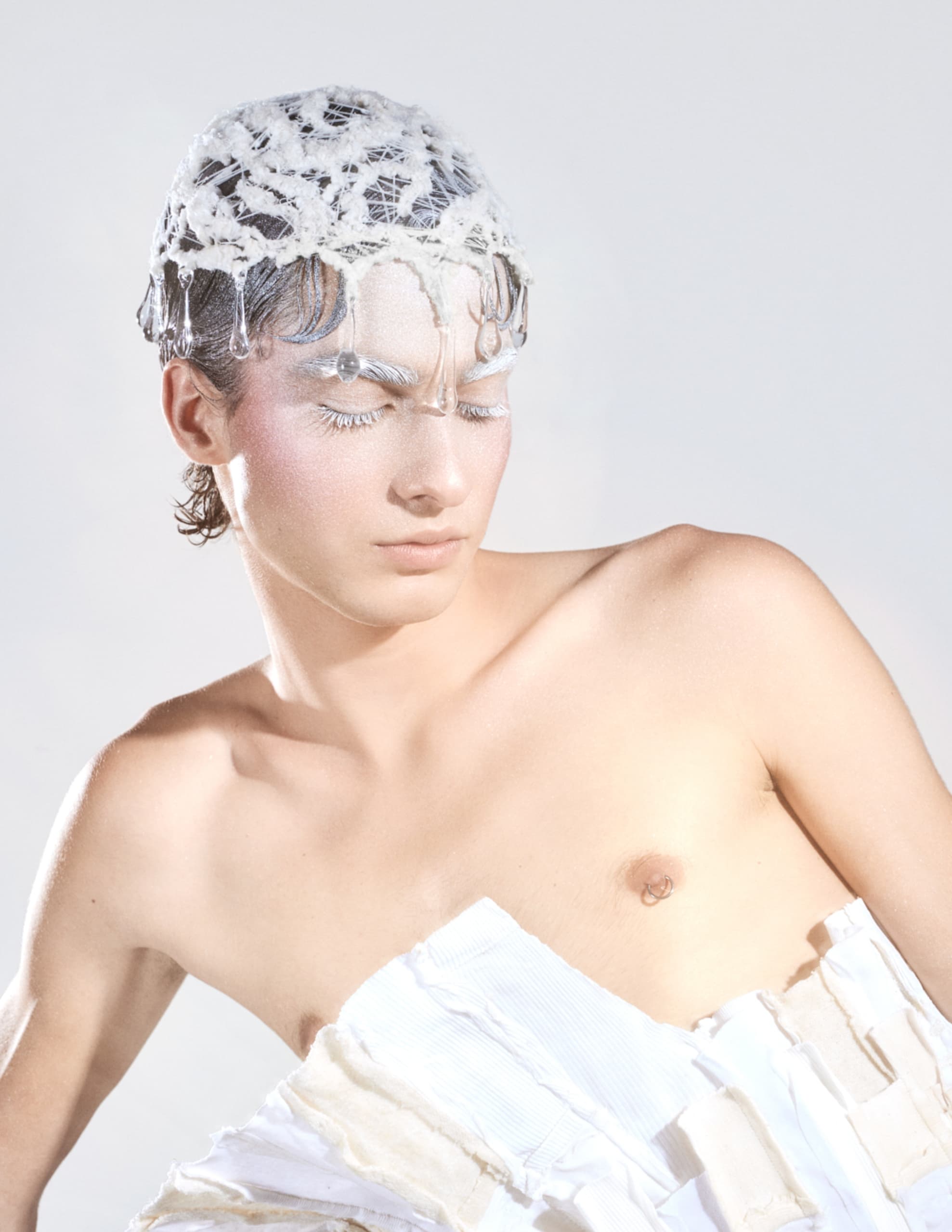 Futuristic fashion look with lace headpiece and artistic makeup.