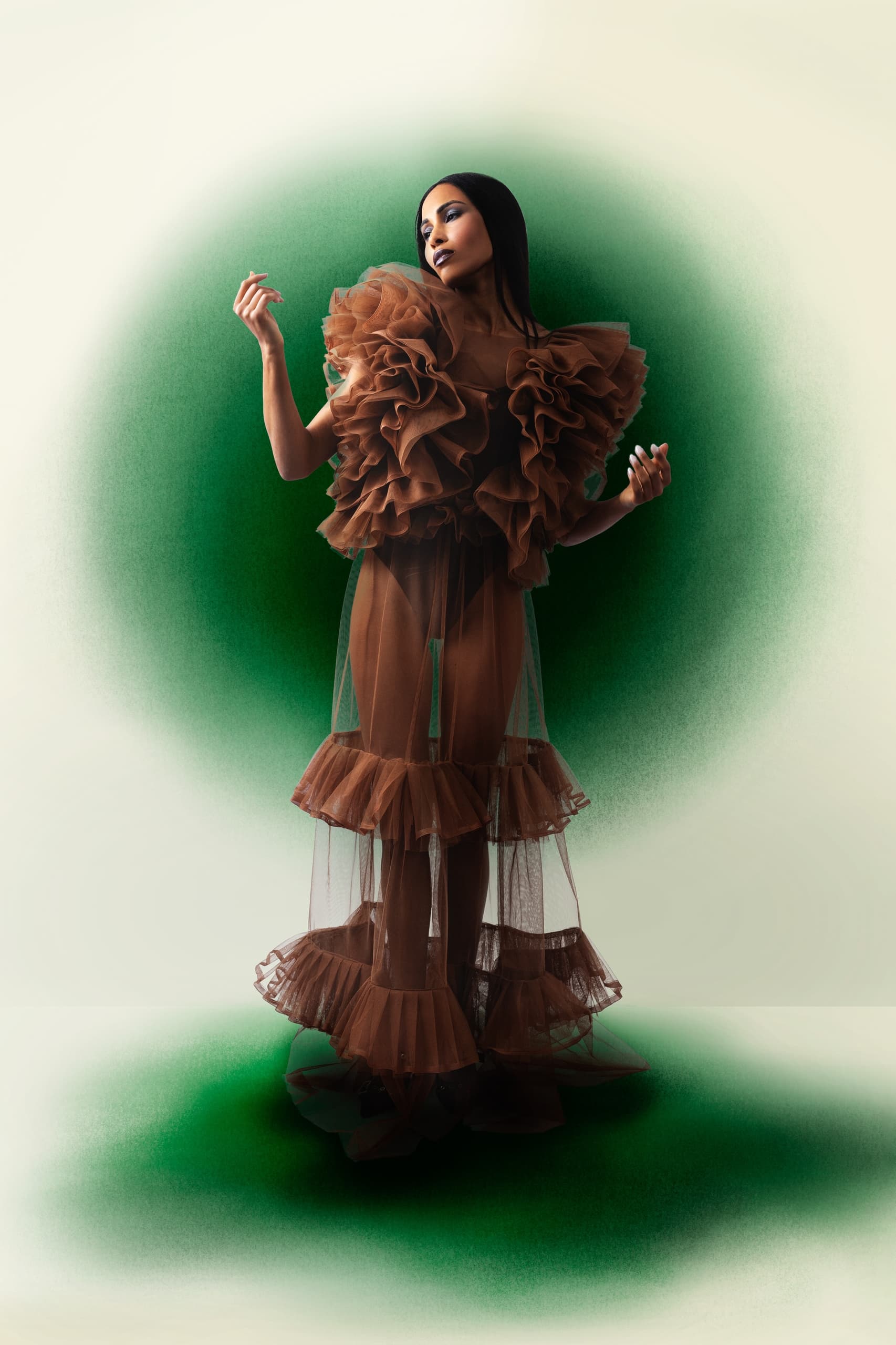 Elegant woman in ruffled brown gown, green background highlights fashion art.