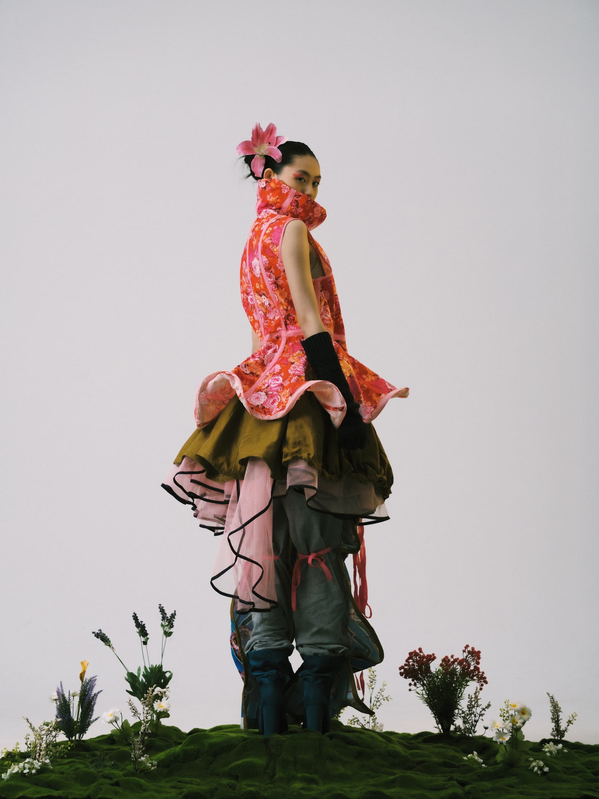 Avant-garde fashion with floral accents and layered textures.