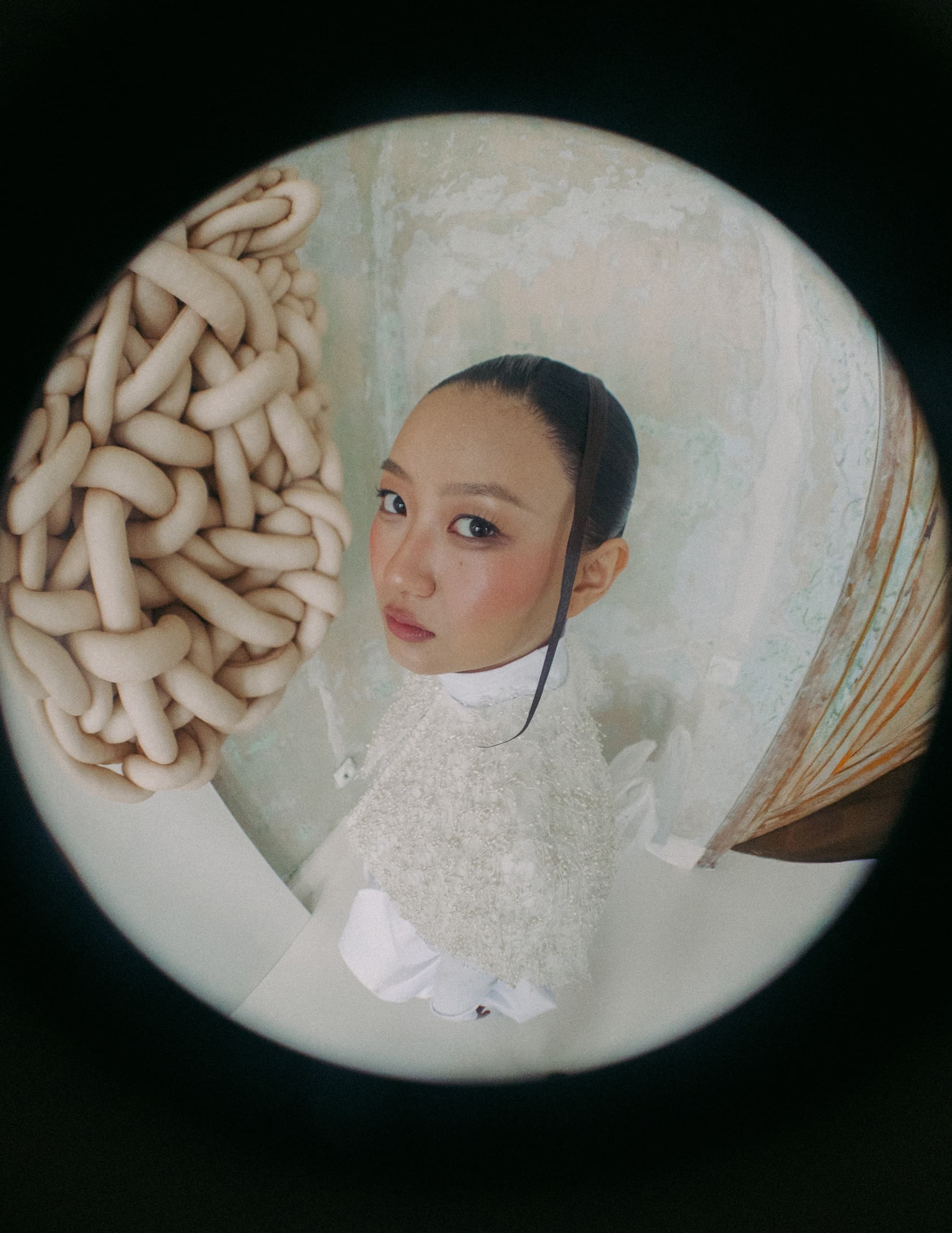 Young woman with artistic setup in fisheye lens view.