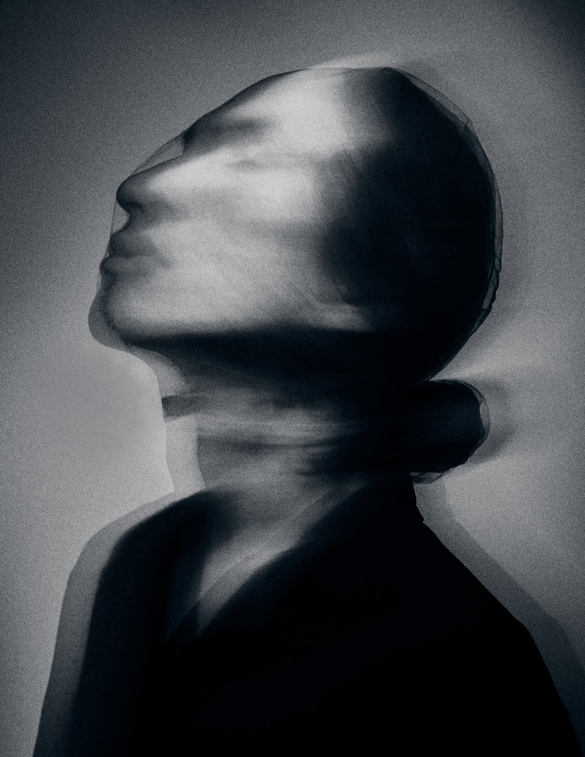 Abstract black and white motion blur portrait of a person looking upwards.