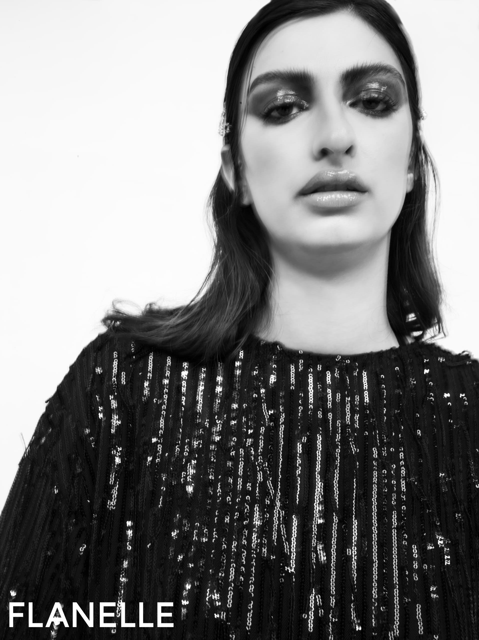 Fashion portrait in sequined dress, black and white style.