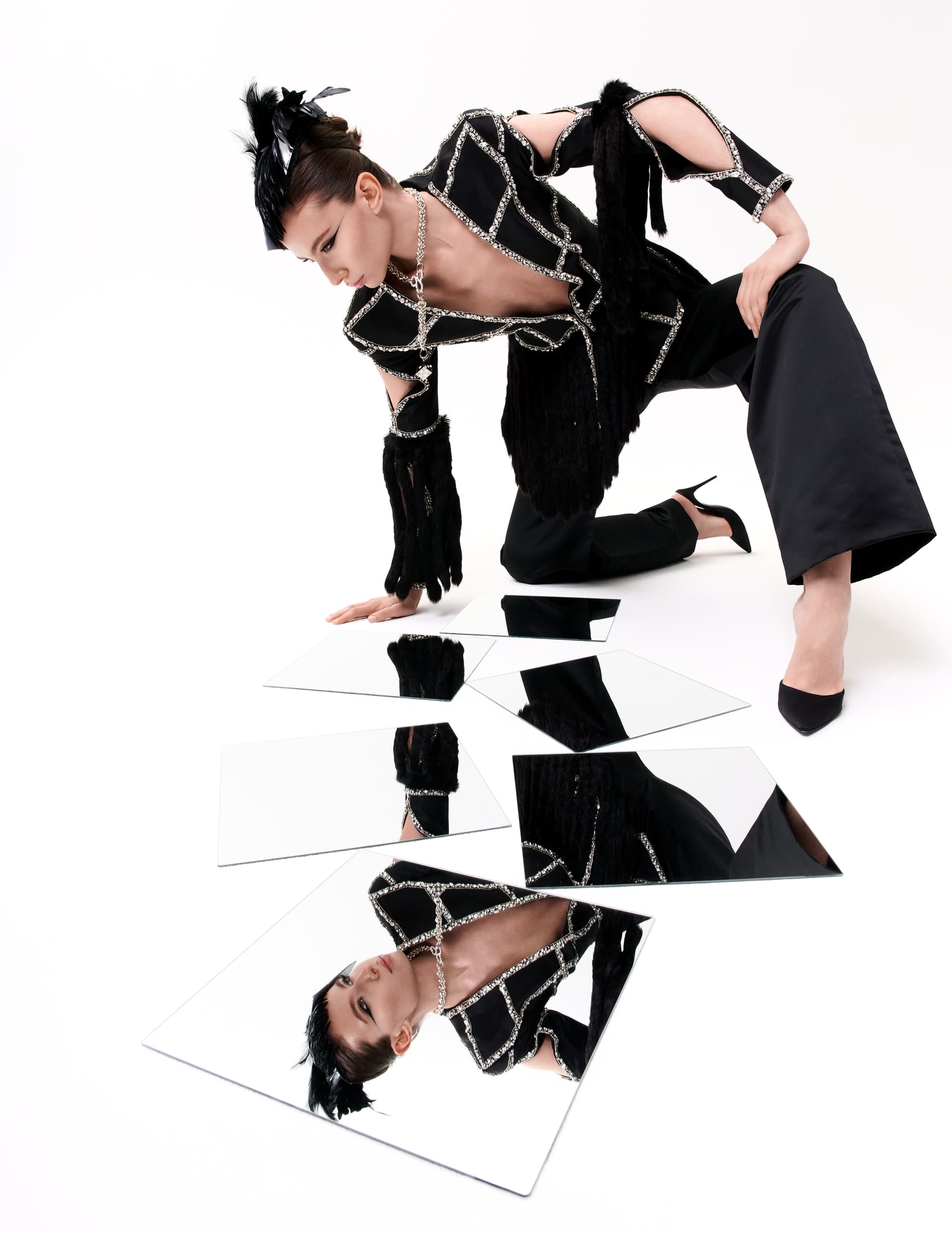 Avant-garde fashion and mirrors creating a striking artistic reflection.