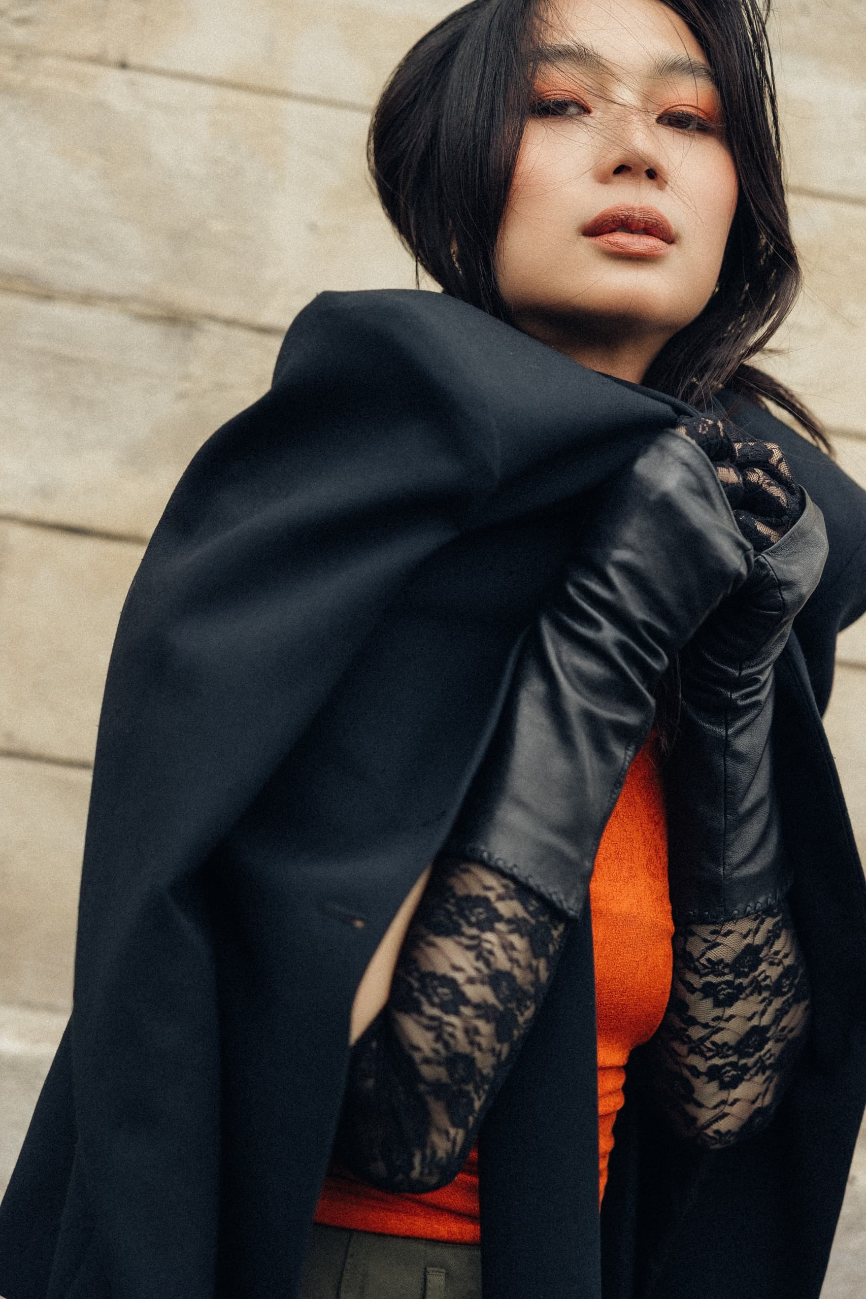 Fashionable woman in lace gloves and elegant coat outdoor portrait.