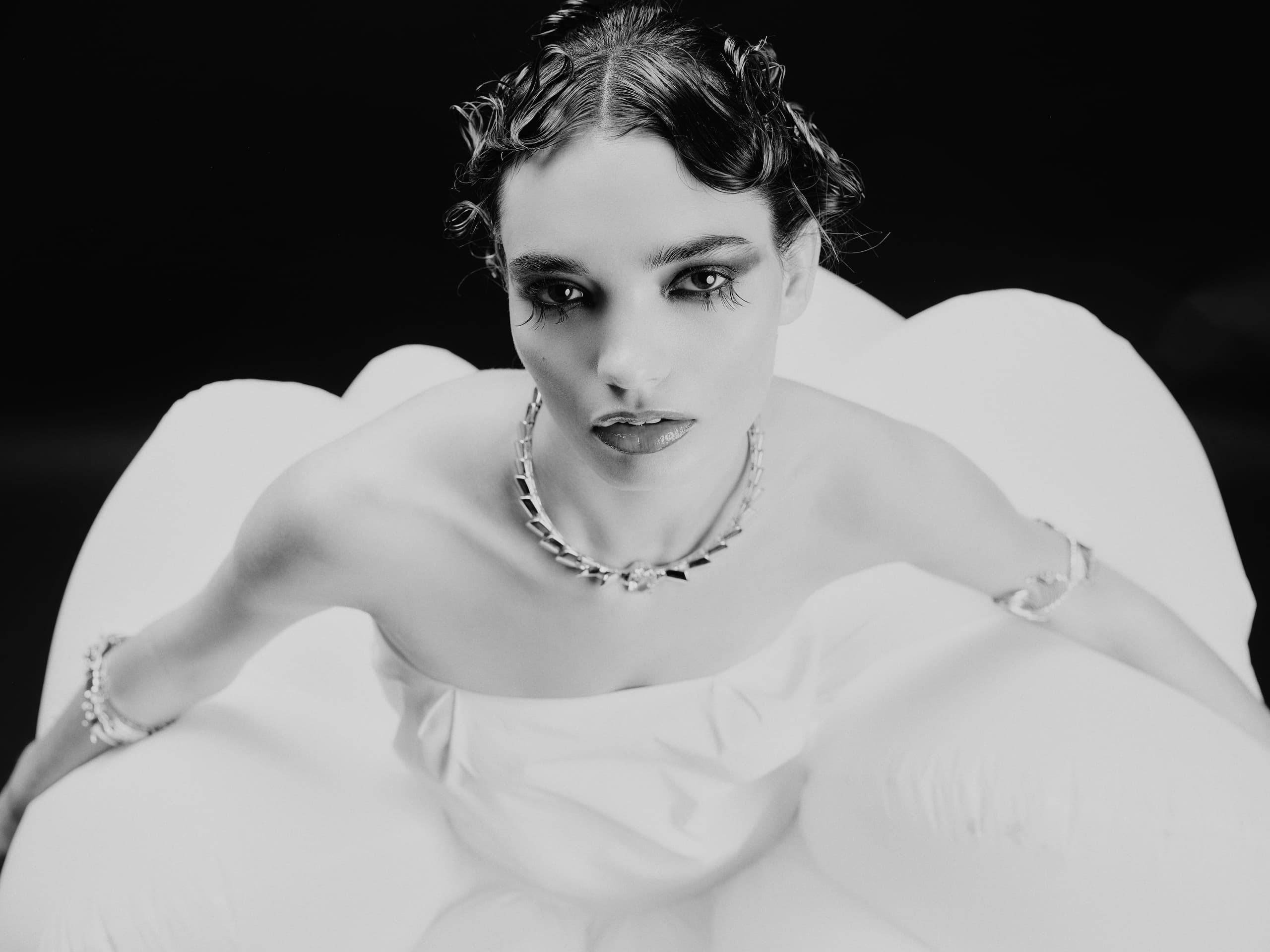 Elegant black and white portrait of a woman in glamorous attire, vintage style.