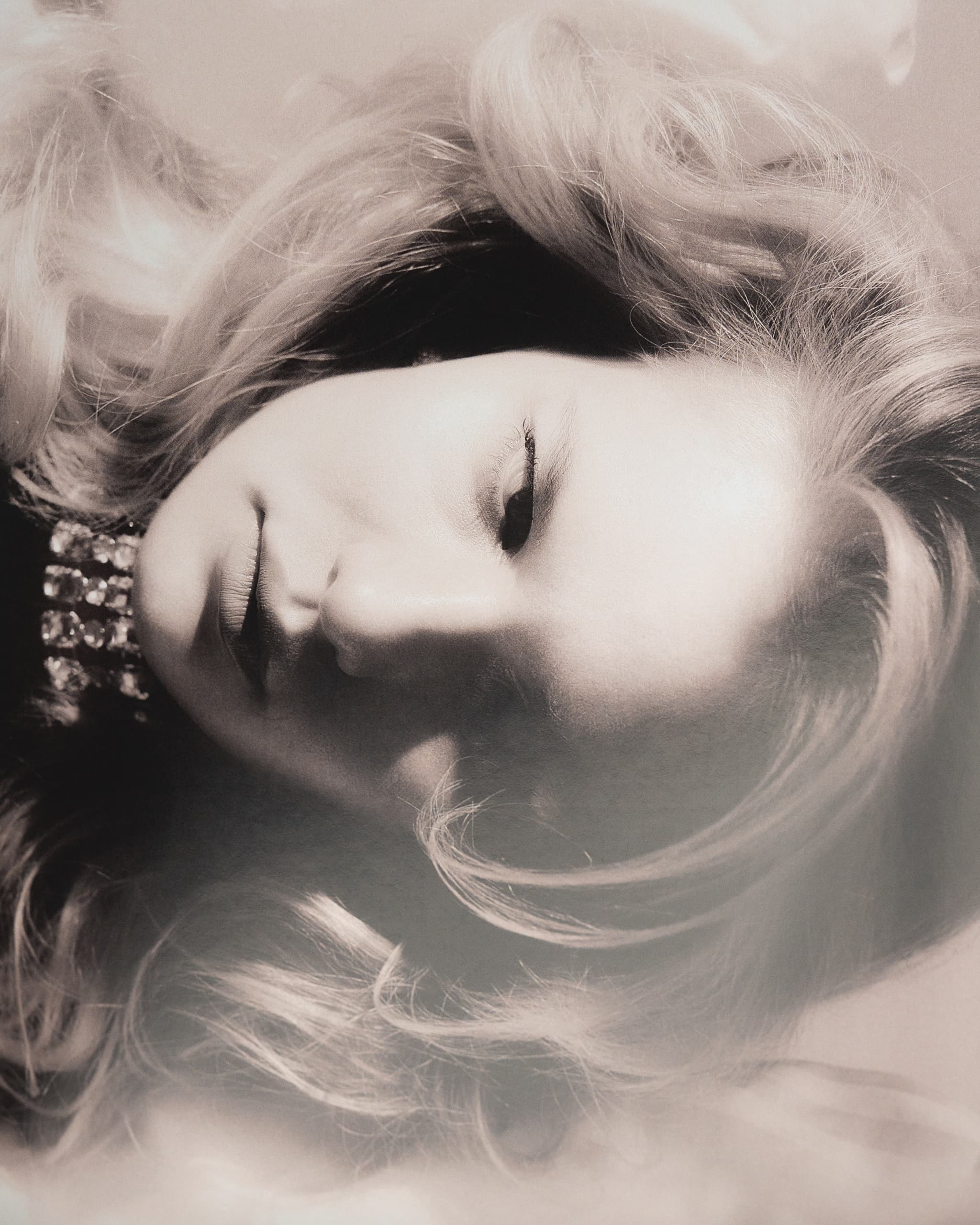 Black and white portrait with woman and flowing hair, elegant vintage style.