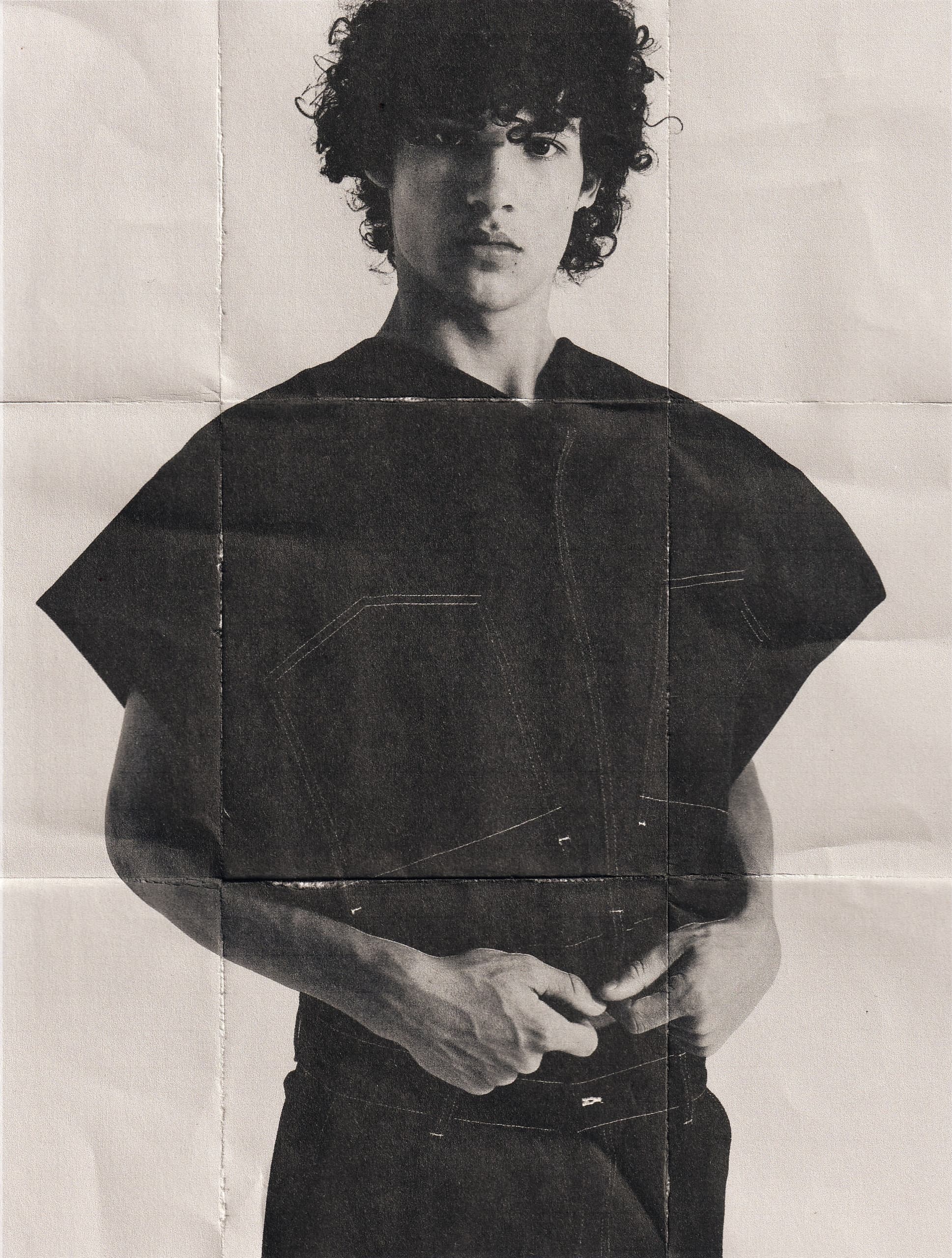 Fashion model in a black and white portrait wearing a stylish dark shirt.