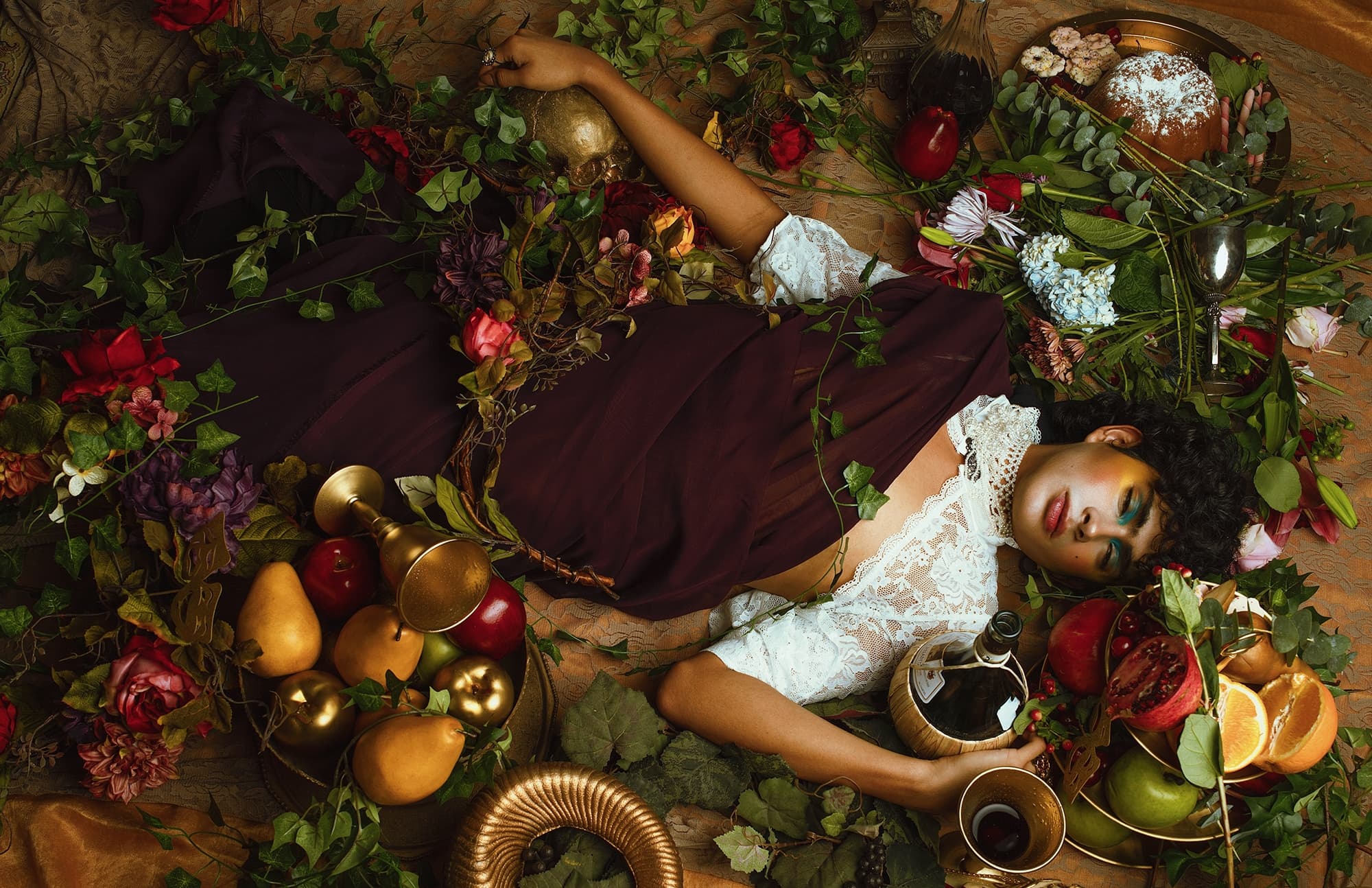 Elegant tableau with fruits, flowers, and person in lace, evoking a classic still life.