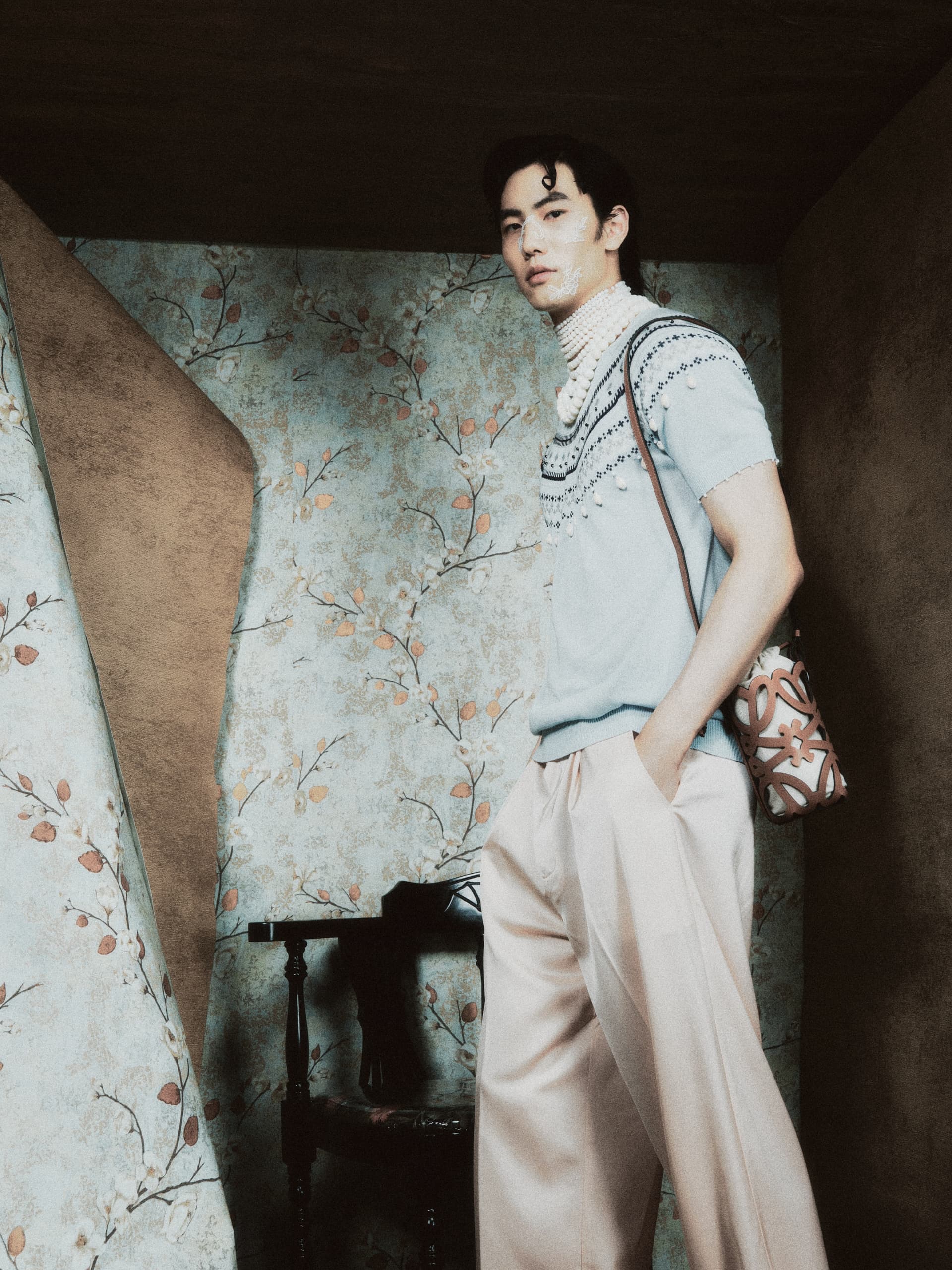 Fashionable person in stylish outfit, vintage floral background.