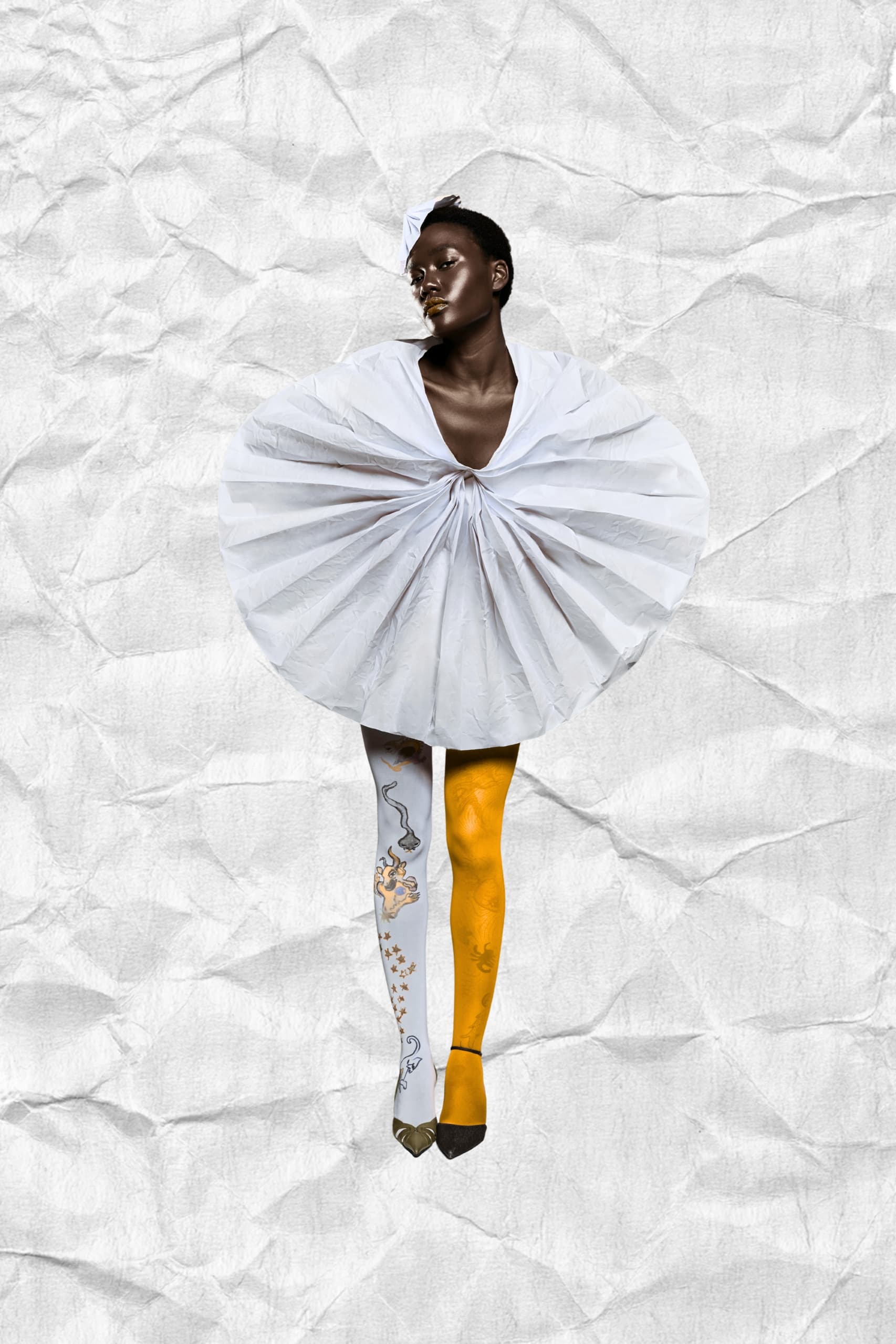 Model in avant-garde fashion outfit, textured background.