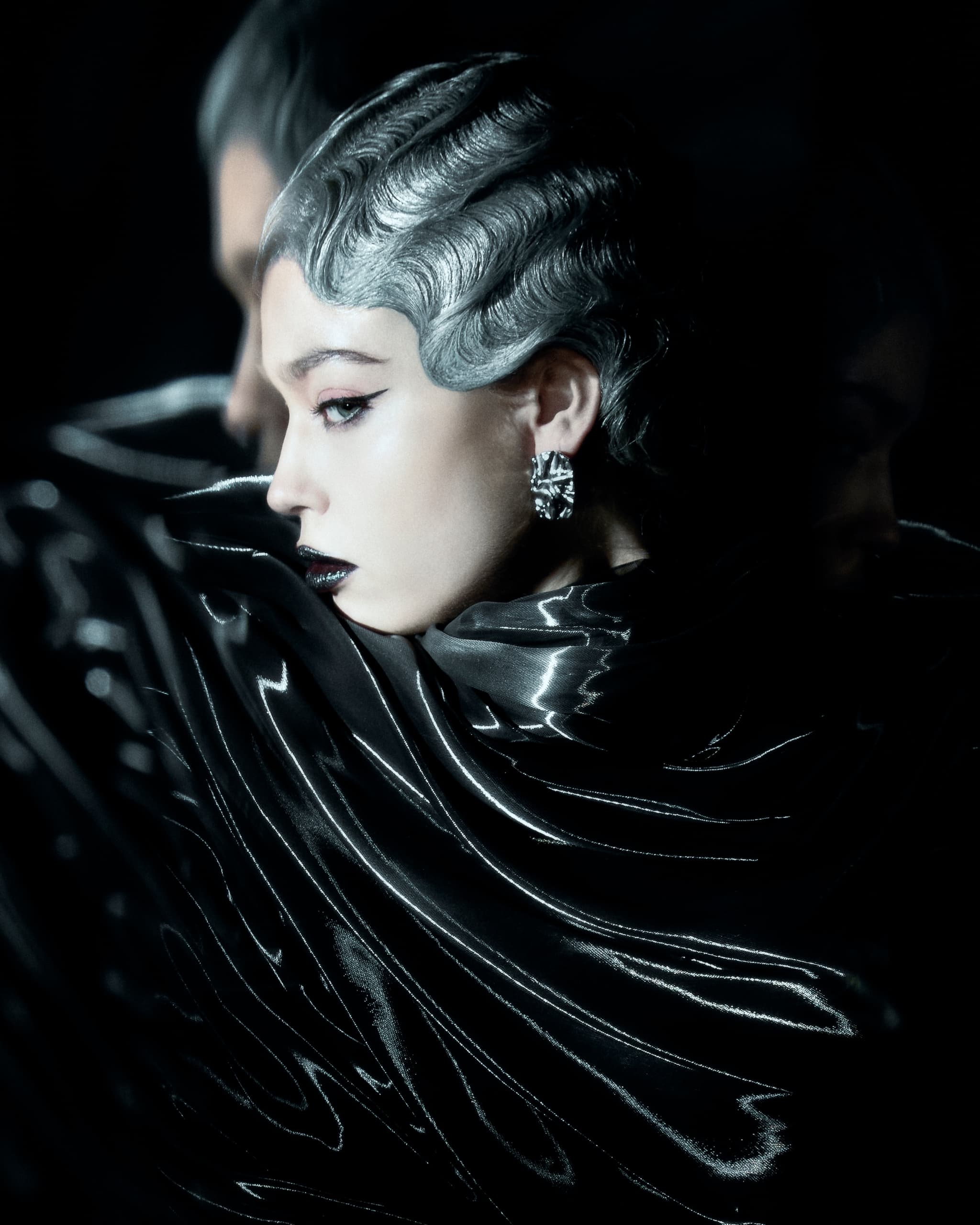 Elegant woman in shiny, futuristic outfit and silver hair, side profile.