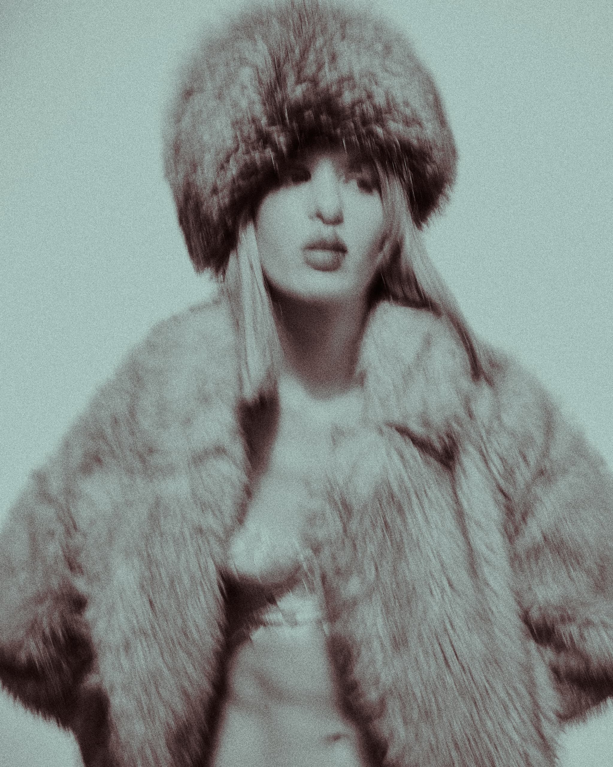 Stylish woman in a vintage fur coat and hat, soft-focus portrait.