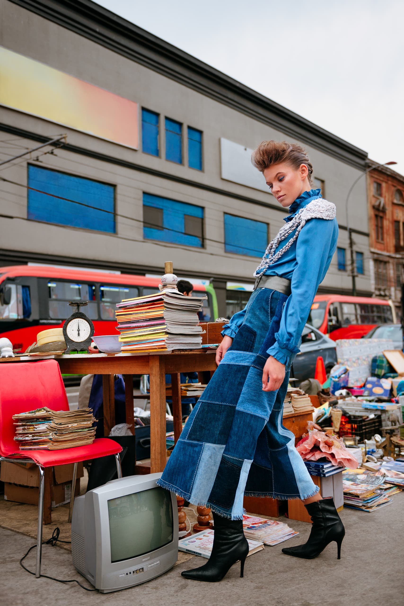 Fashionable woman in retro outfit at a quirky street market.