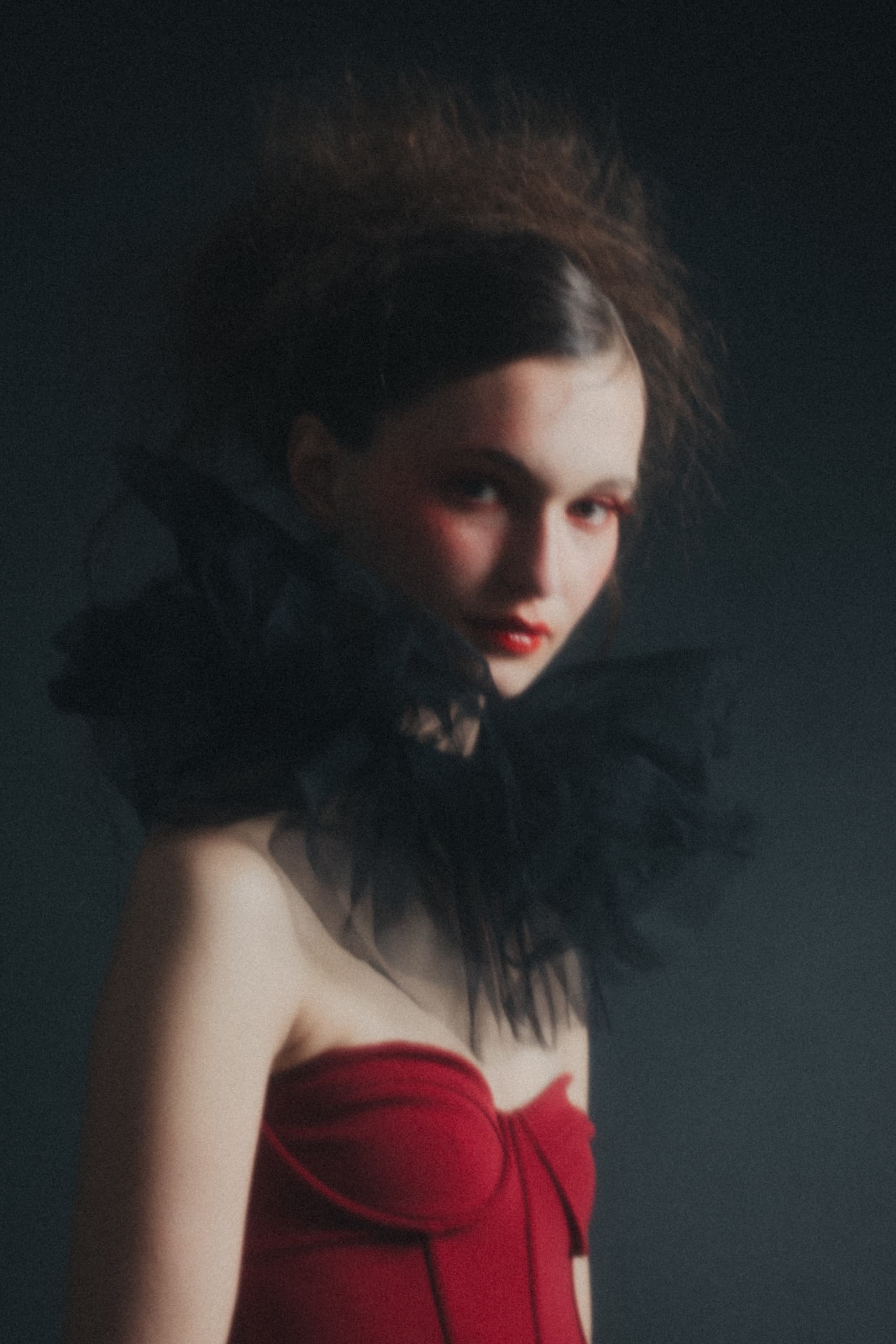Vintage fashion portrait of woman in red dress with dramatic black collar.