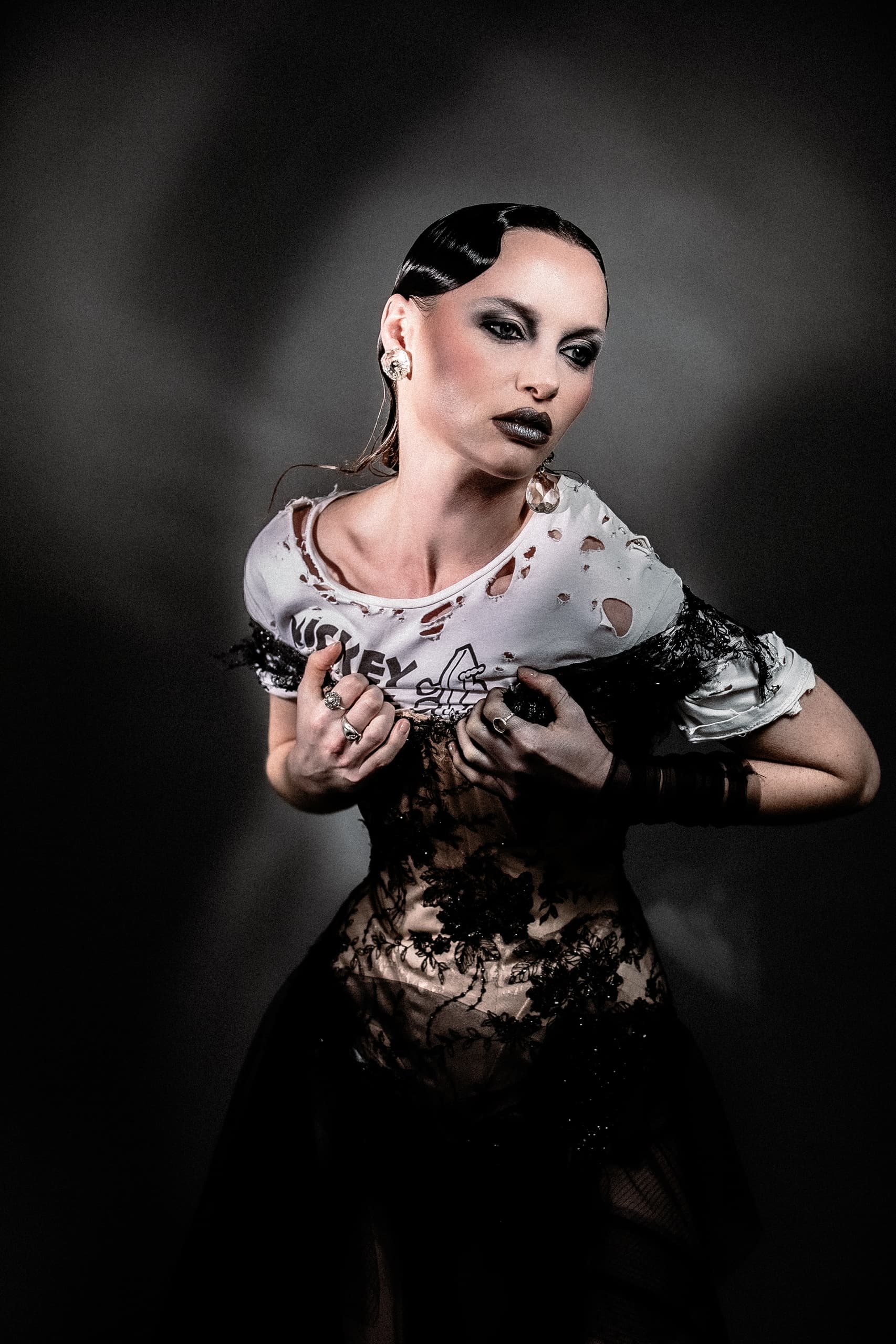 Edgy fashion model posing in a dramatic, artistic style.