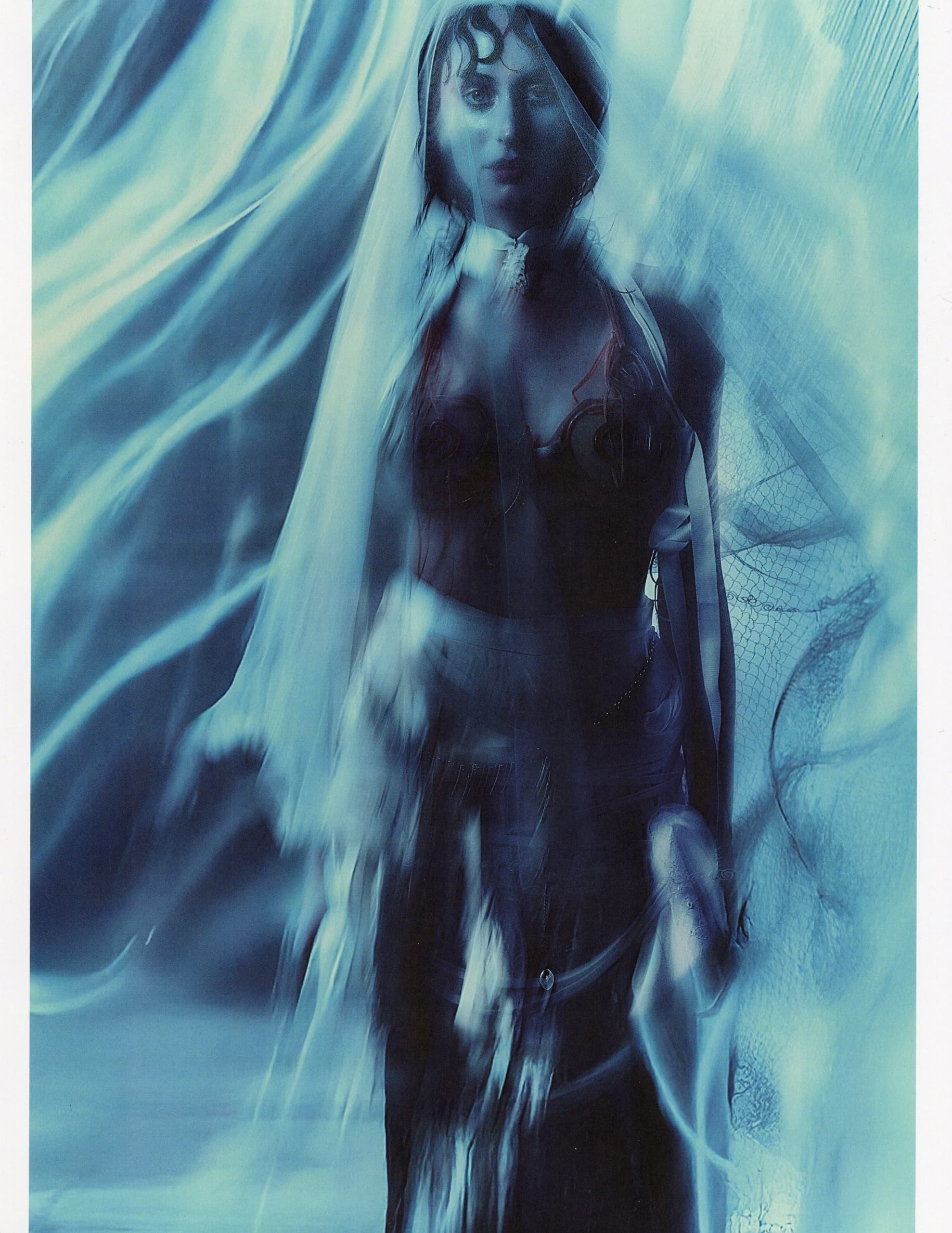 Ethereal woman in flowing blue veil and dress, creating a dreamy, surreal ambiance.