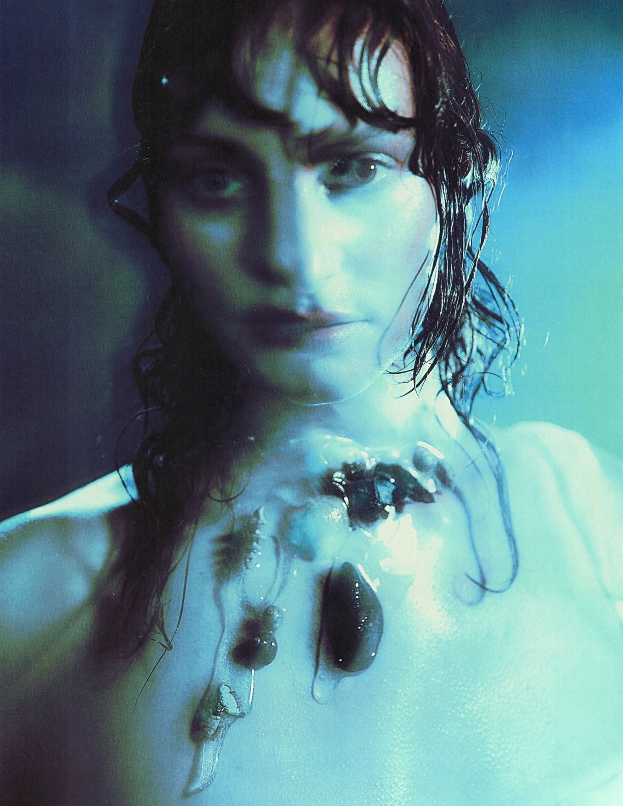 Artistic portrait of a wet-haired person with surreal lighting and abstract details.