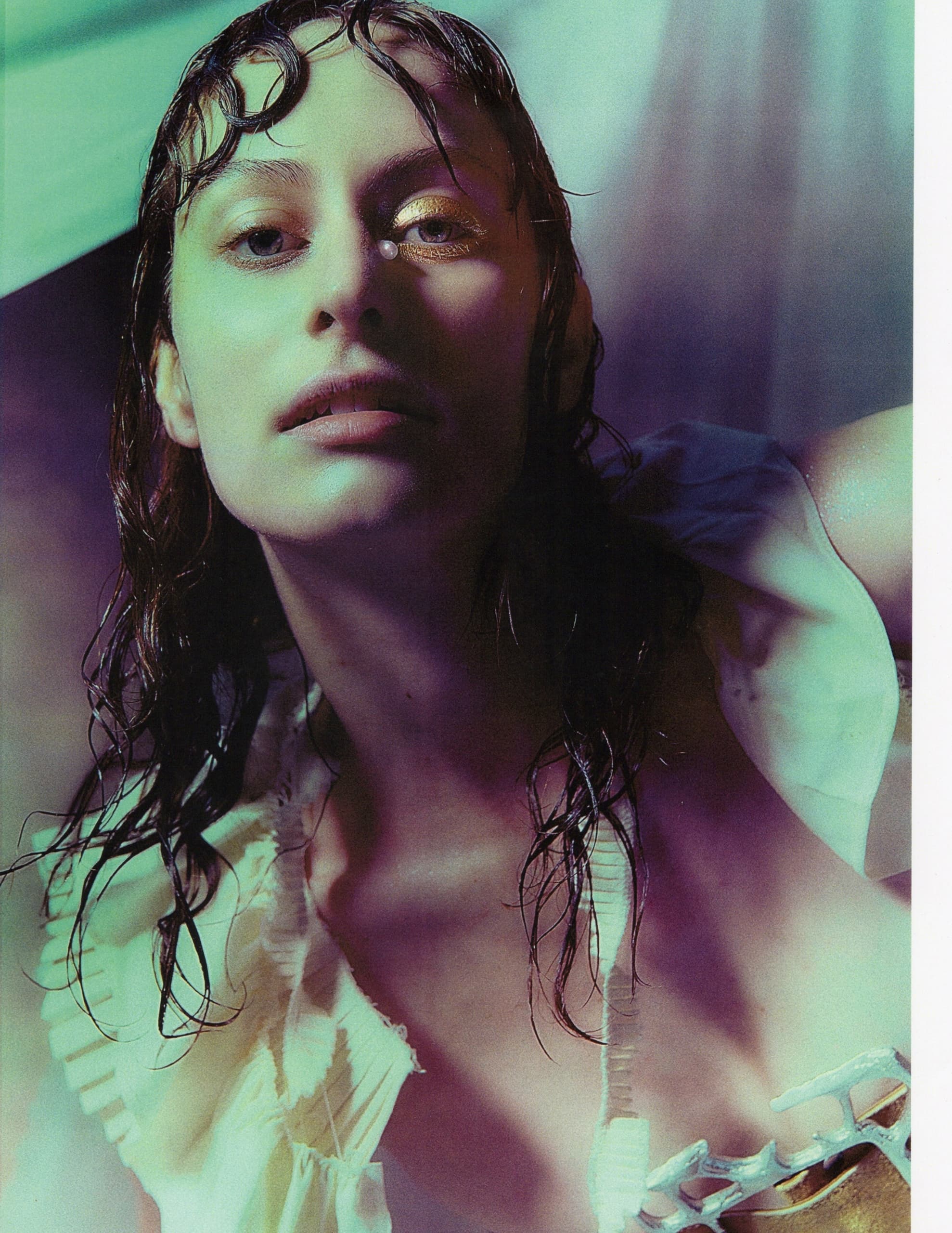 Artistic portrait of a woman with wet hair and unique lighting effects.