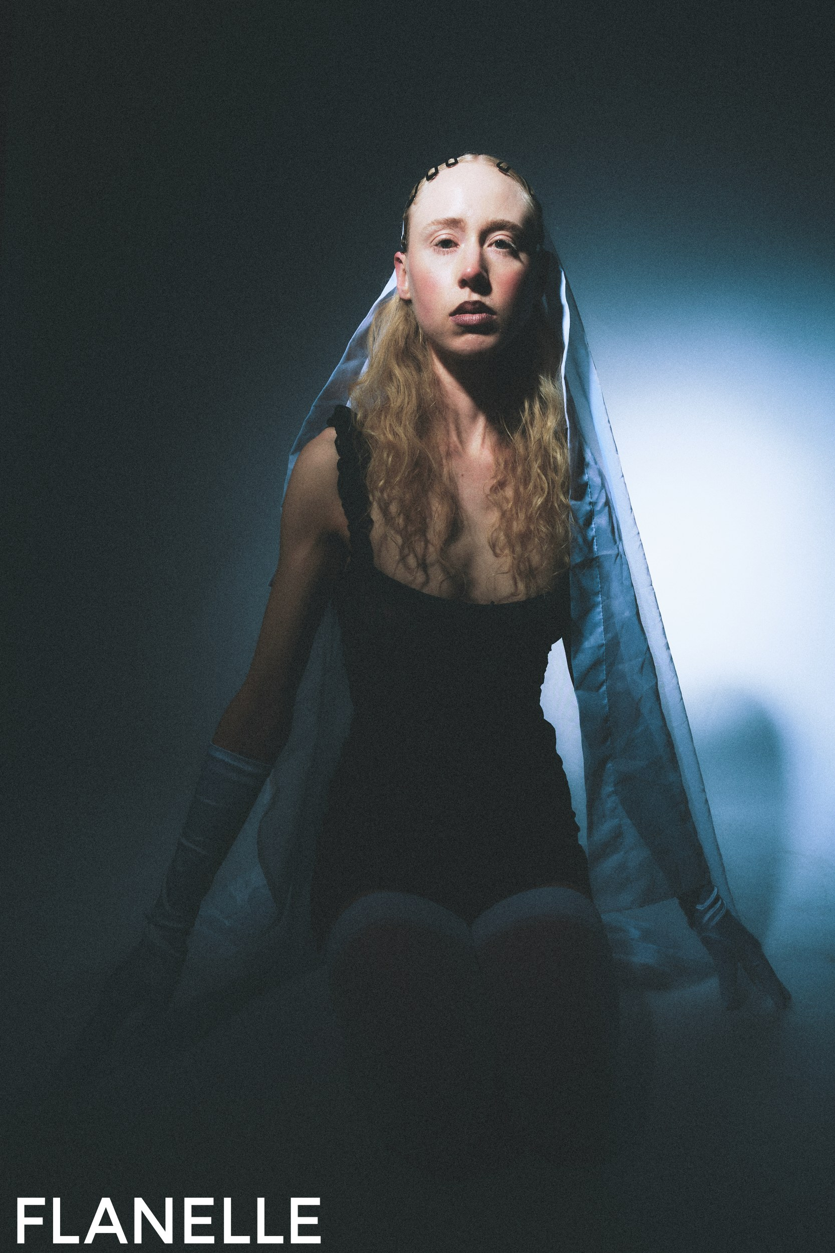 Mysterious woman in black dress with veil, dark lighting, Flanelle fashion.