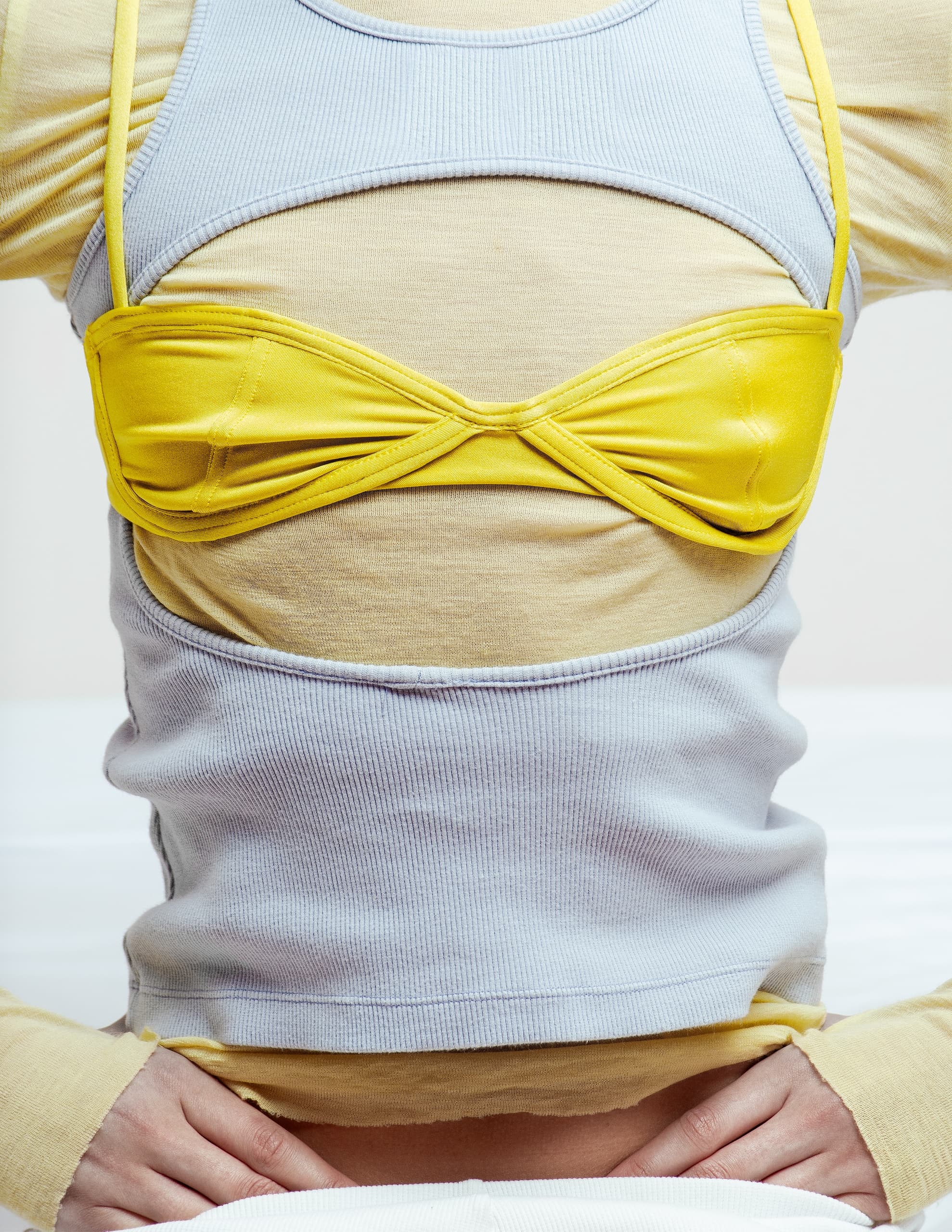 Layered fashion look featuring yellow top and light grey crop tank.