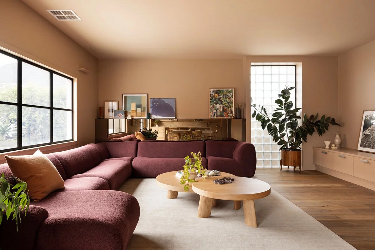 Stylish living room with a burgundy sectional and modern décor.