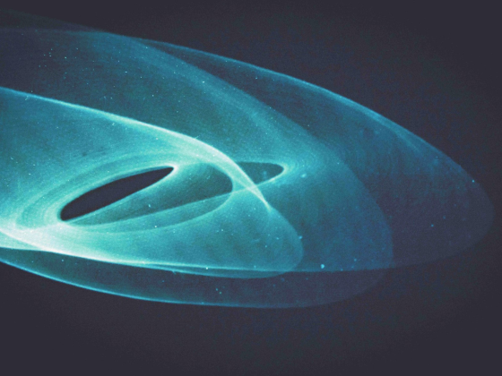 Abstract blue light trails on a dark background.