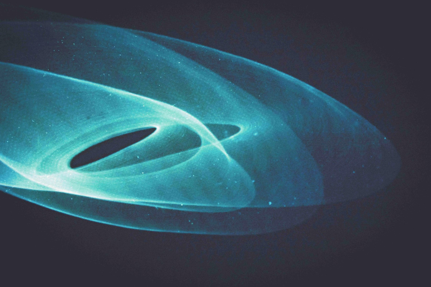 Abstract blue light trails on a dark background.