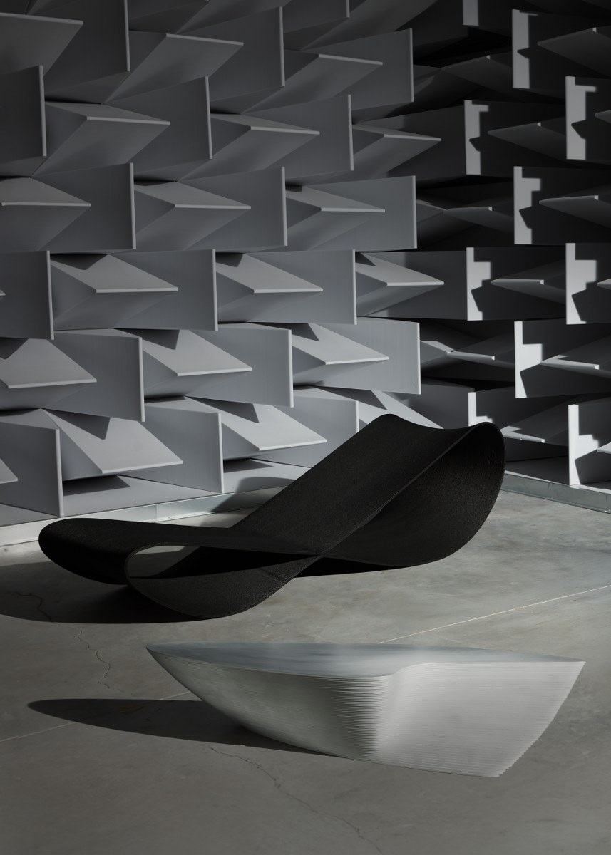 Modern abstract furniture in anechoic chamber with geometric wall design.