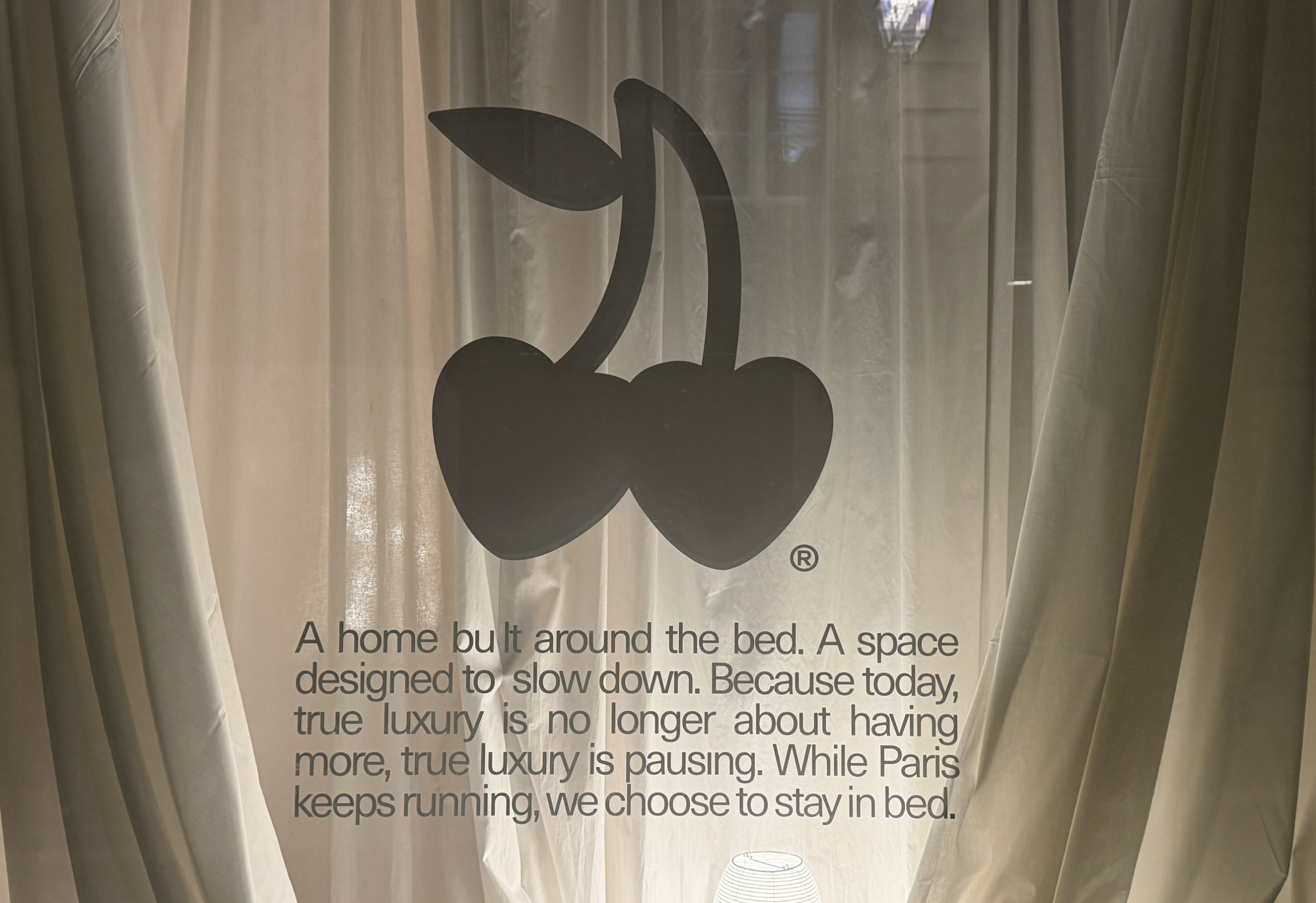 Cherry logo with luxury home text on sheer curtains.