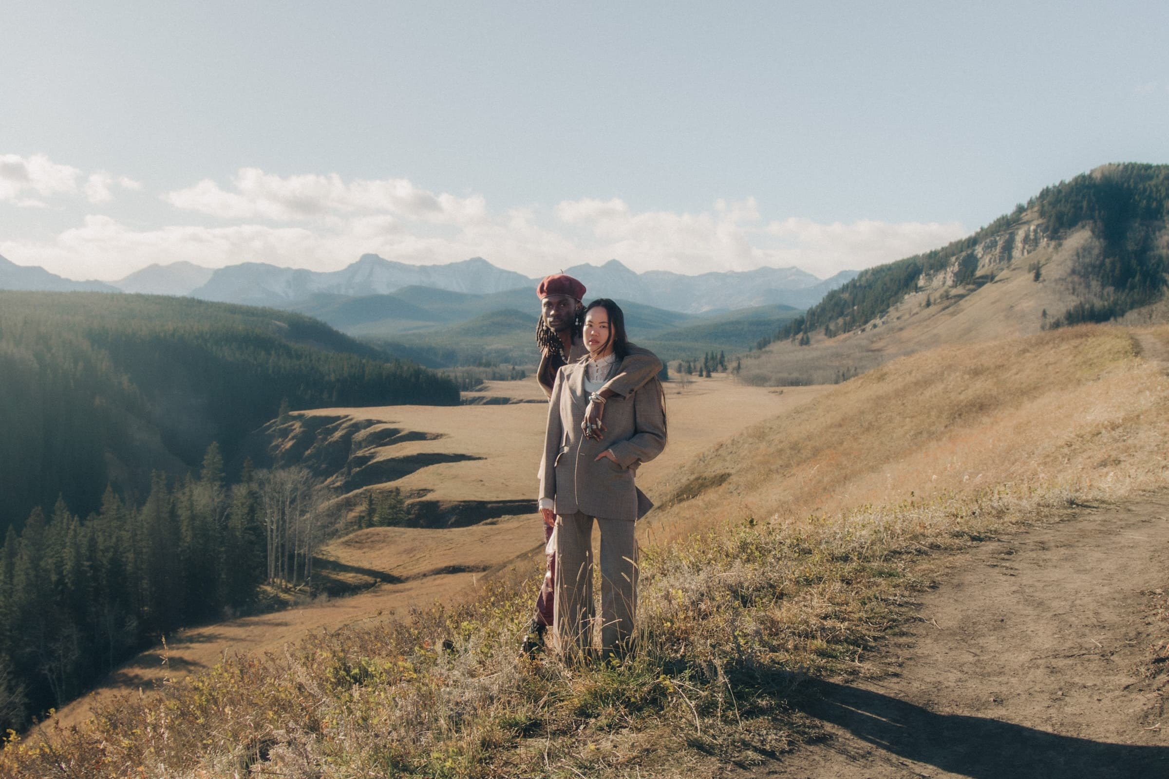 Couple enjoys a scenic mountain view on a sunny day in nature.