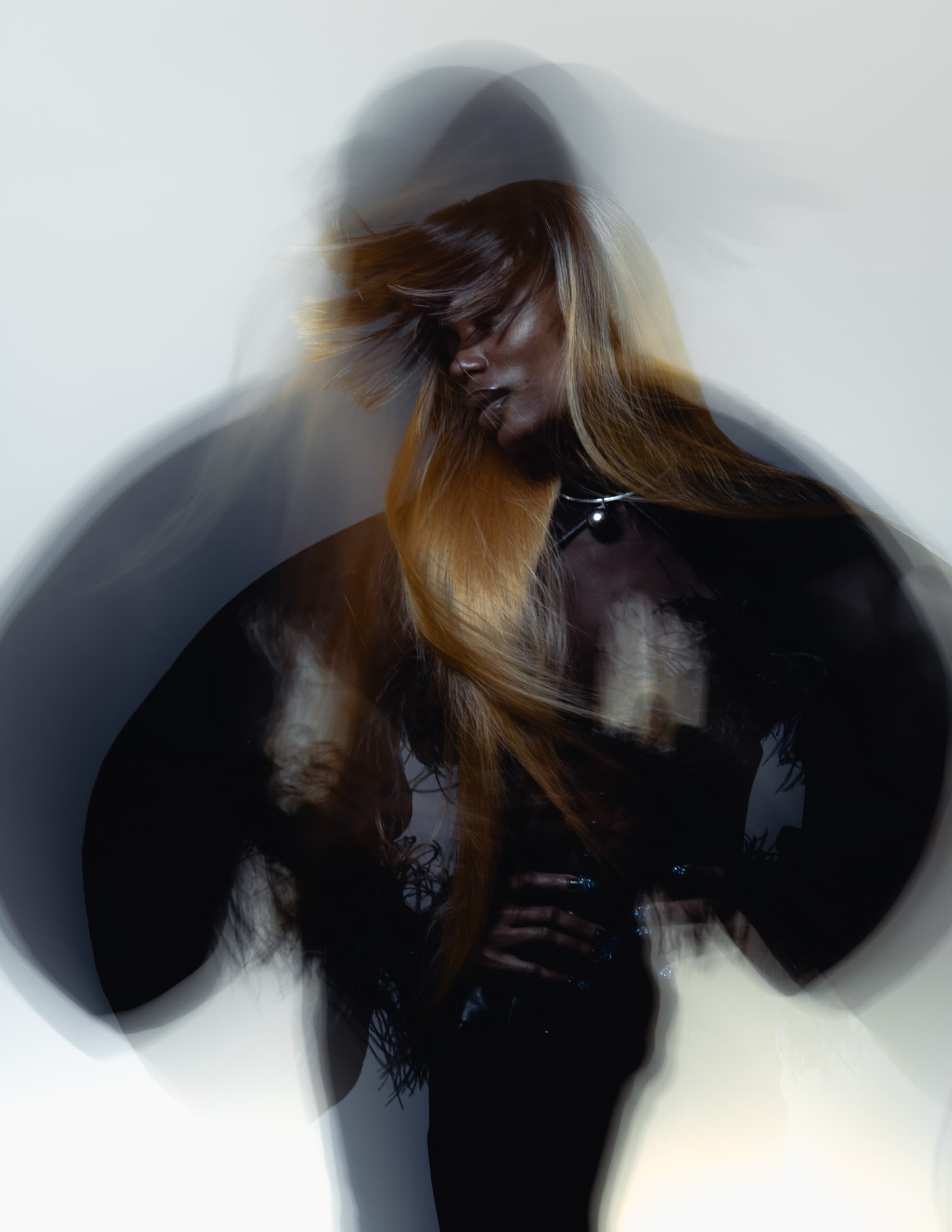 Artistic blurred motion portrait with long hair and dynamic movement.