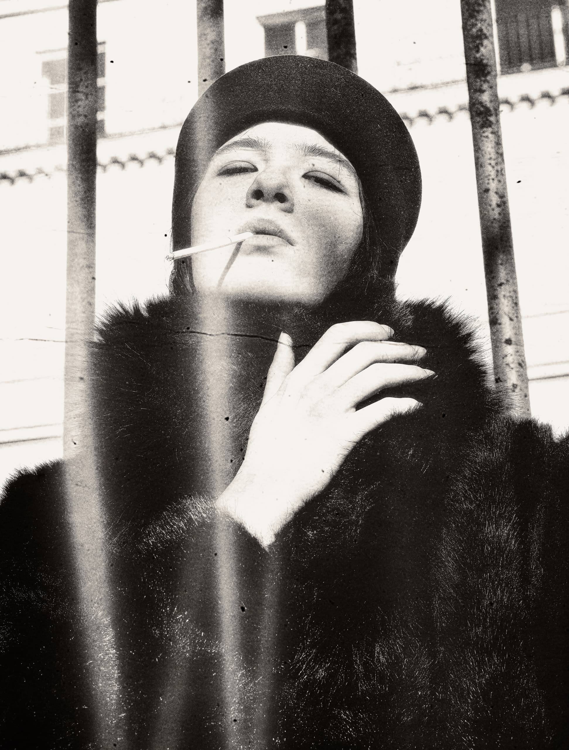 Vintage portrait of a stylish person in fur coat, smoking, with a confident expression.