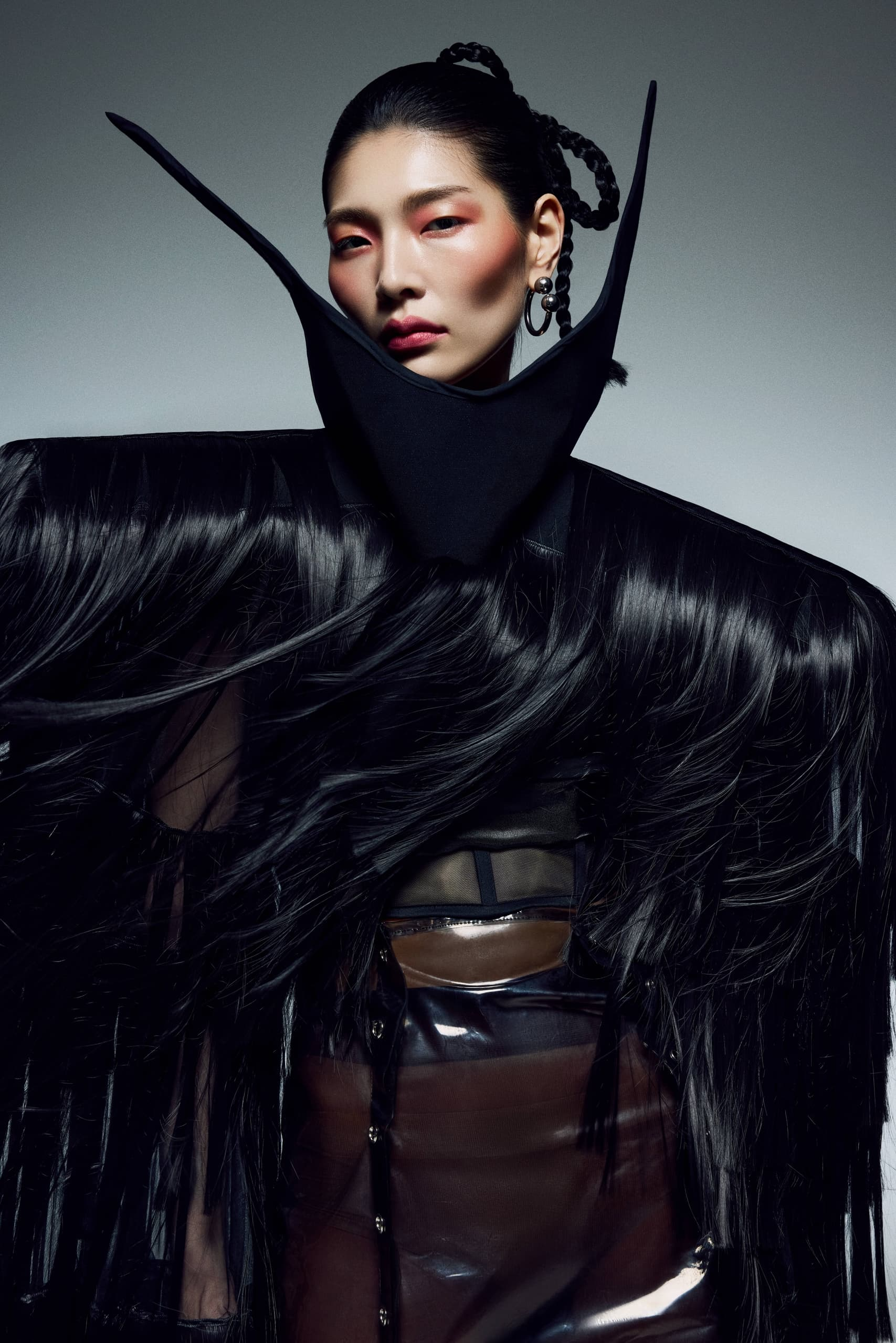 Avant-garde fashion portrait with bold, futuristic style and dramatic textures.
