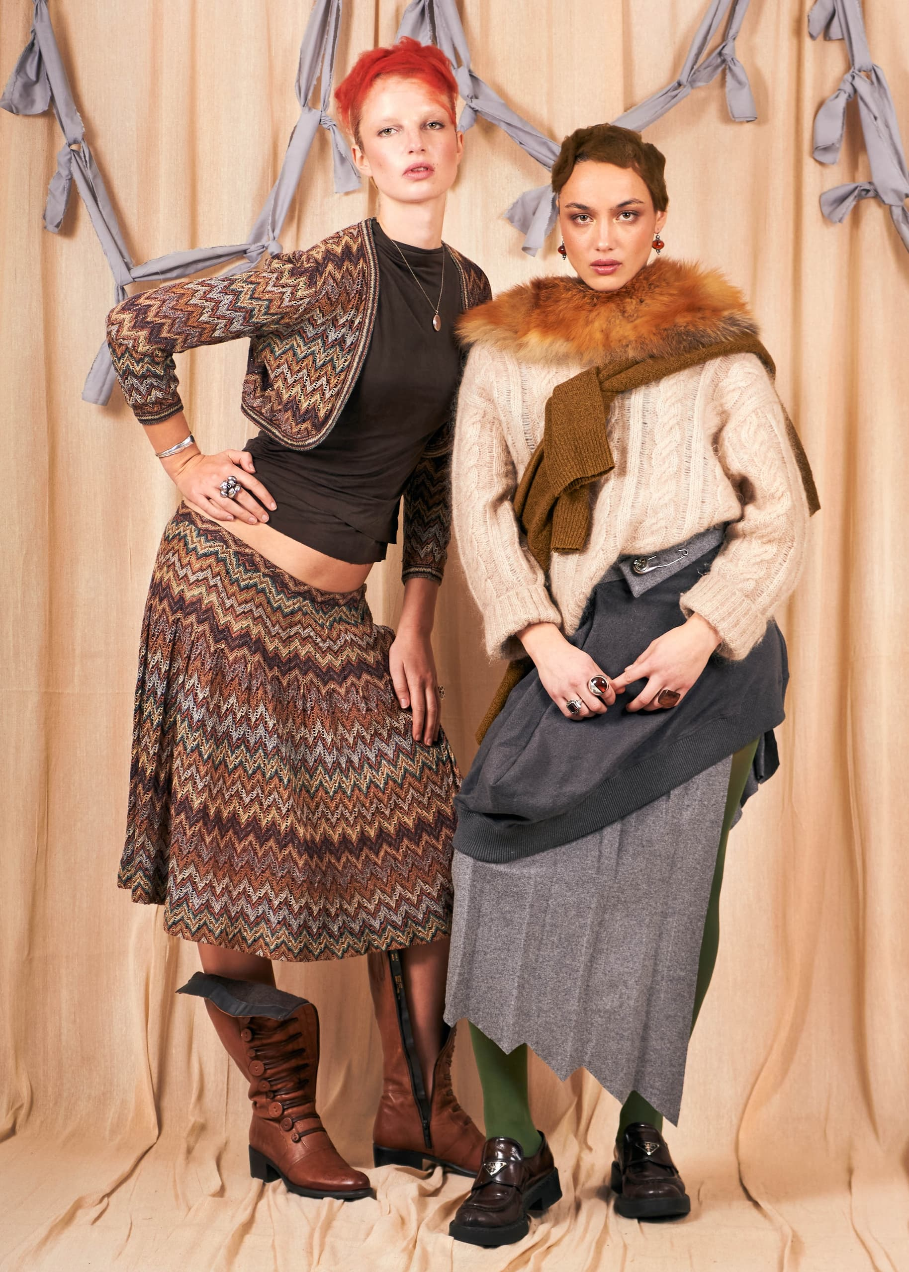 Two models showcase bohemian and vintage fashion styles in a cozy setting.