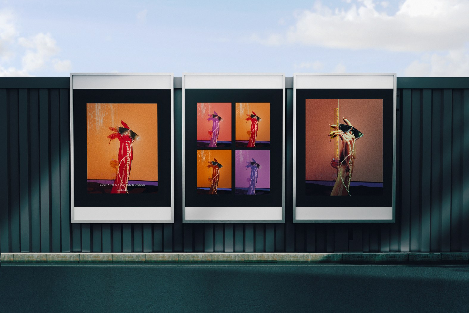 Modern art posters displayed on a fence under a bright, cloudy sky.
