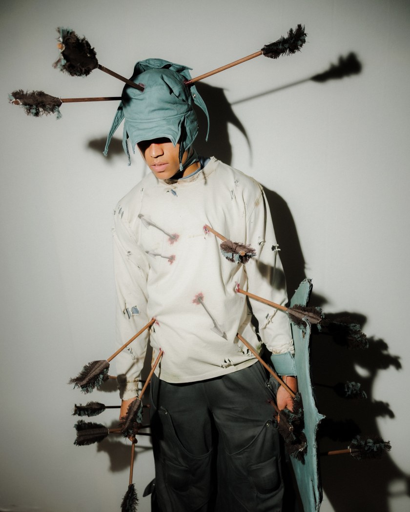 Person in creative costume with arrows pierced through clothing.