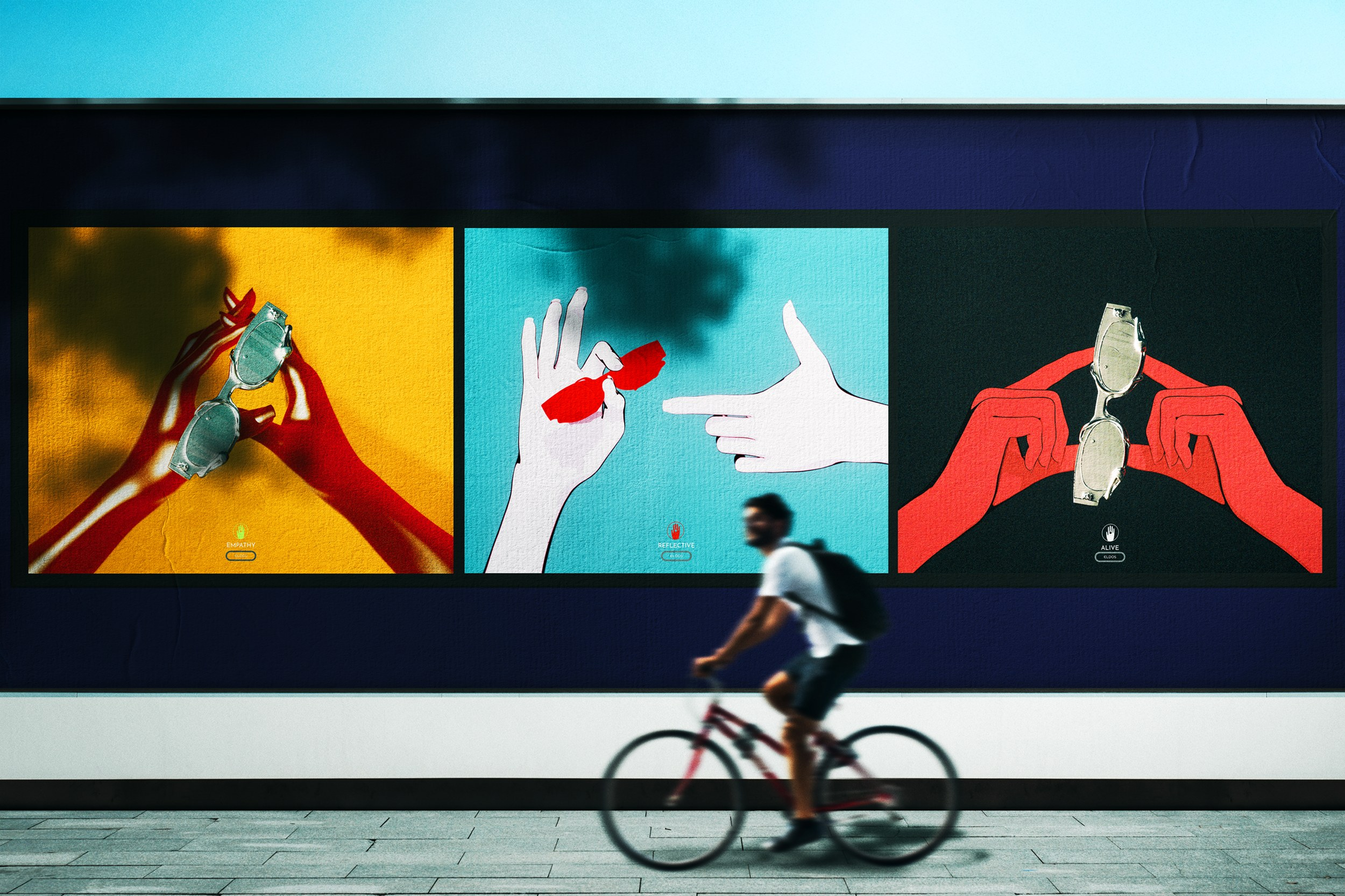 Colorful billboard art depicting hands with glasses, cyclist passing by in the foreground.