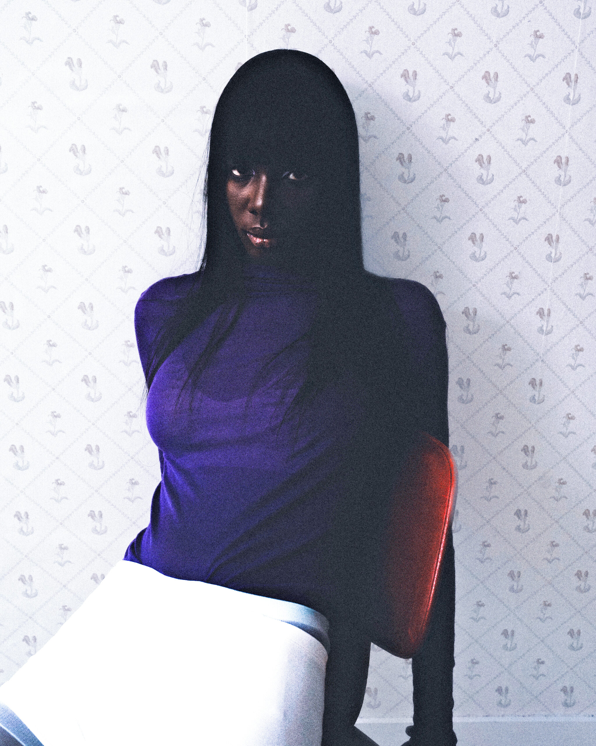 Woman in a purple top sits against a patterned wall, creating a mysterious vibe.