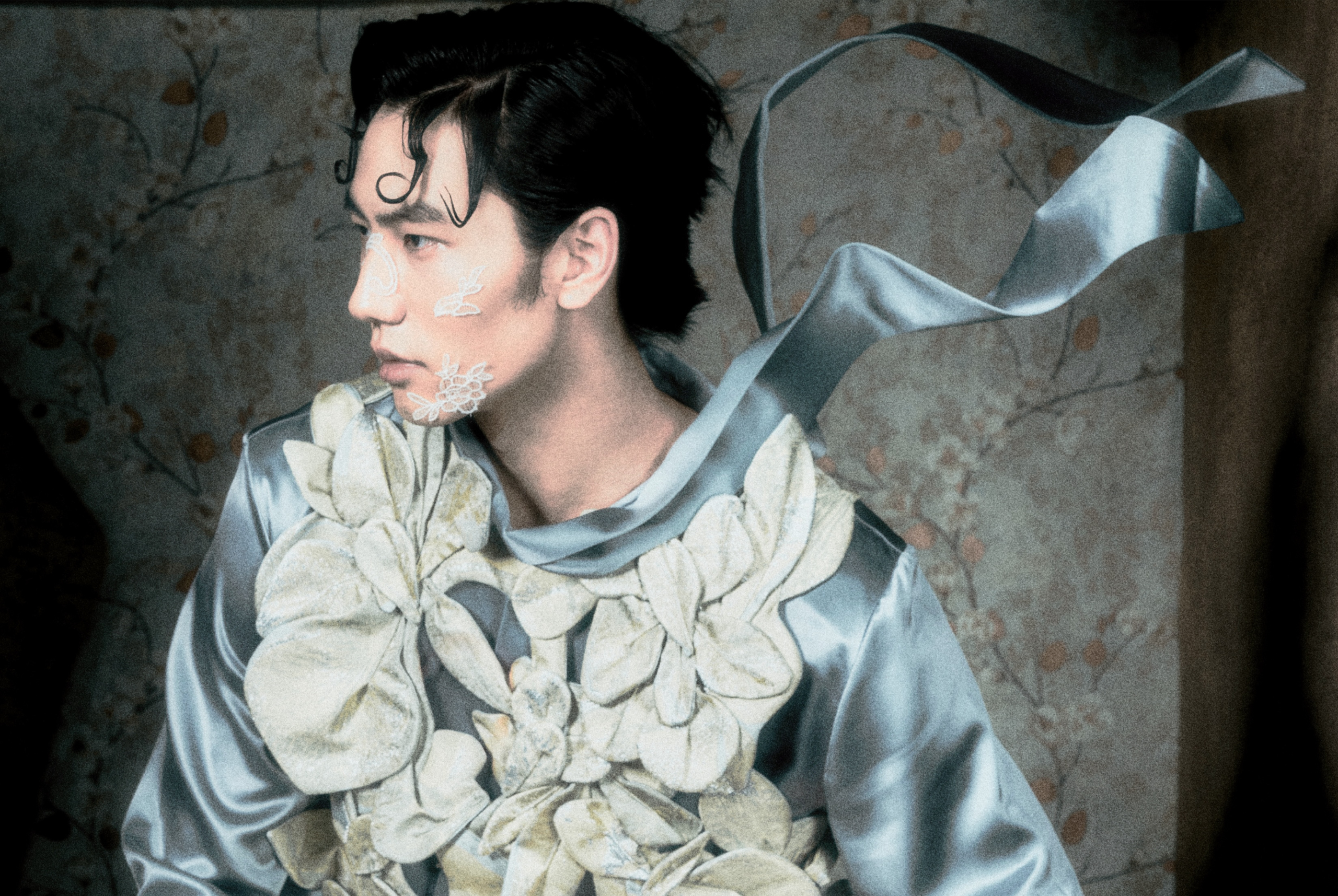 Fashion-forward individual in floral-inspired outfit and artistic face paint.