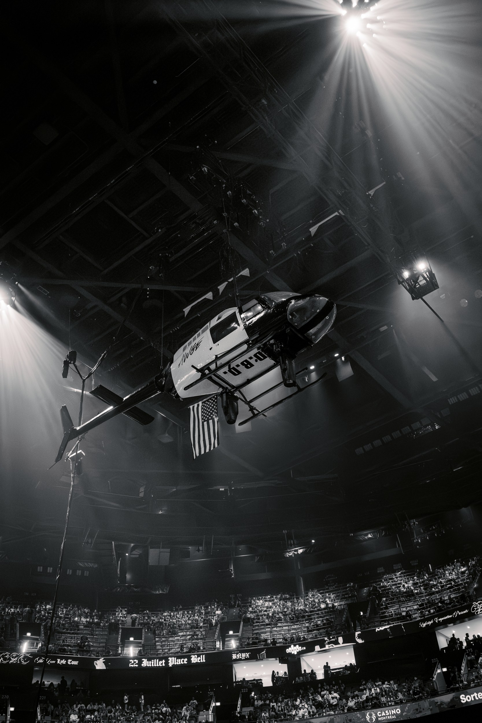 Helicopter suspended inside an arena during an event at a music concert.