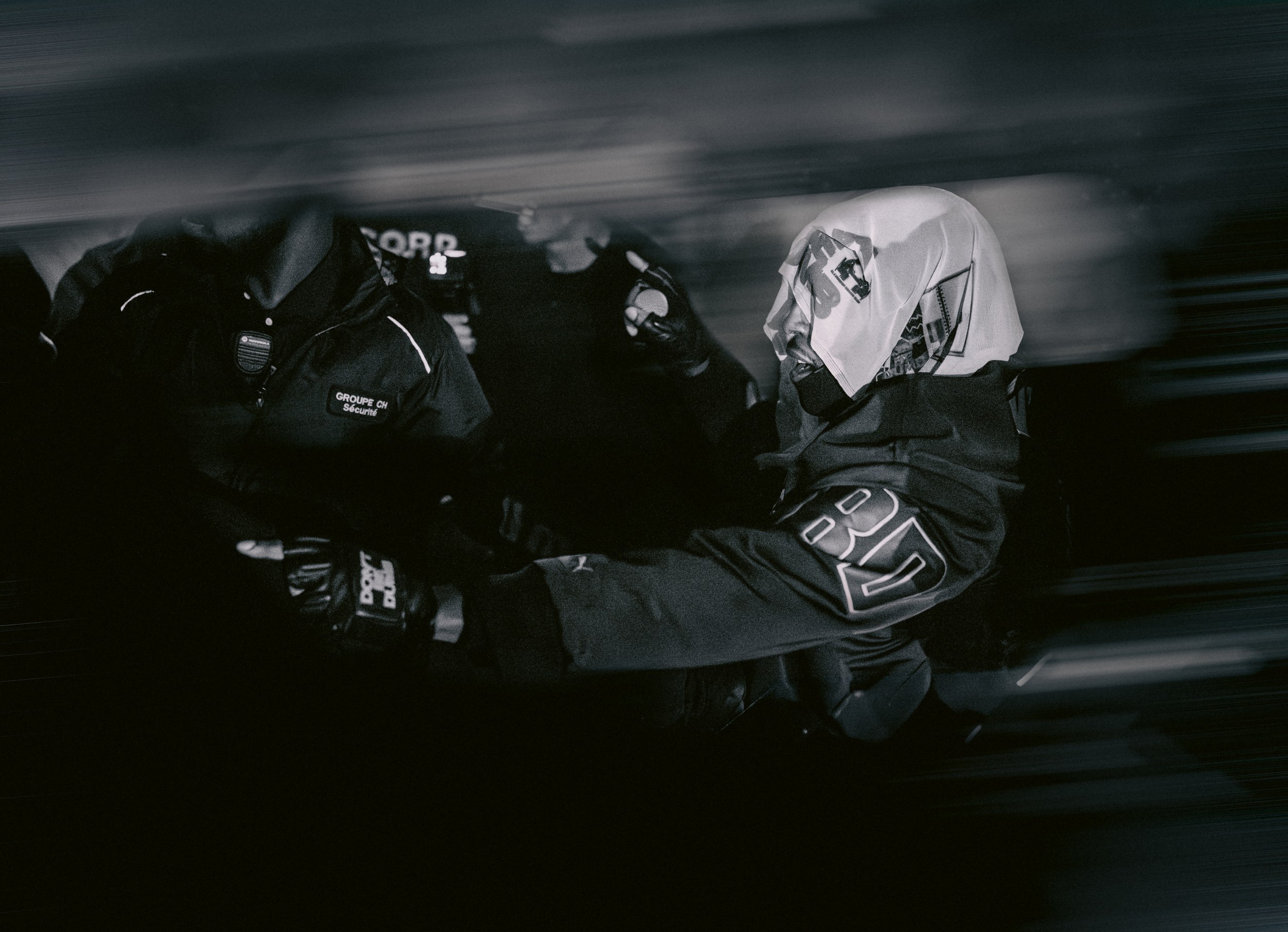 Masked security operatives in action during a dynamic nighttime scene.