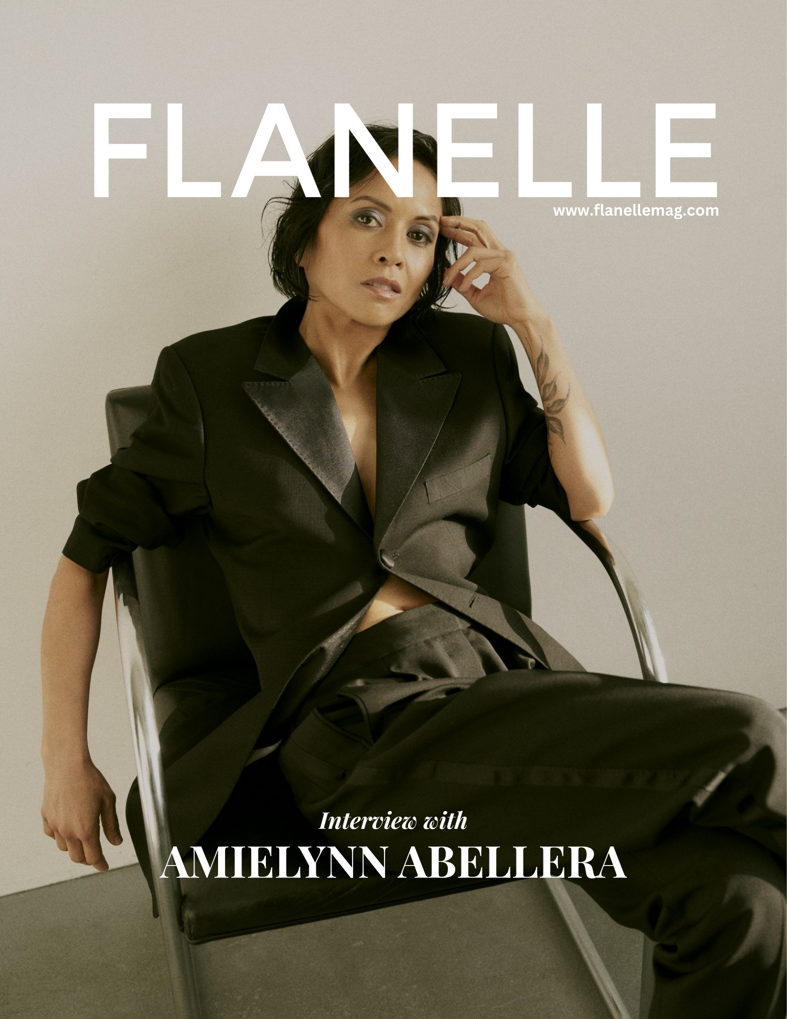 Person posing in black suit on Flanelle magazine cover.