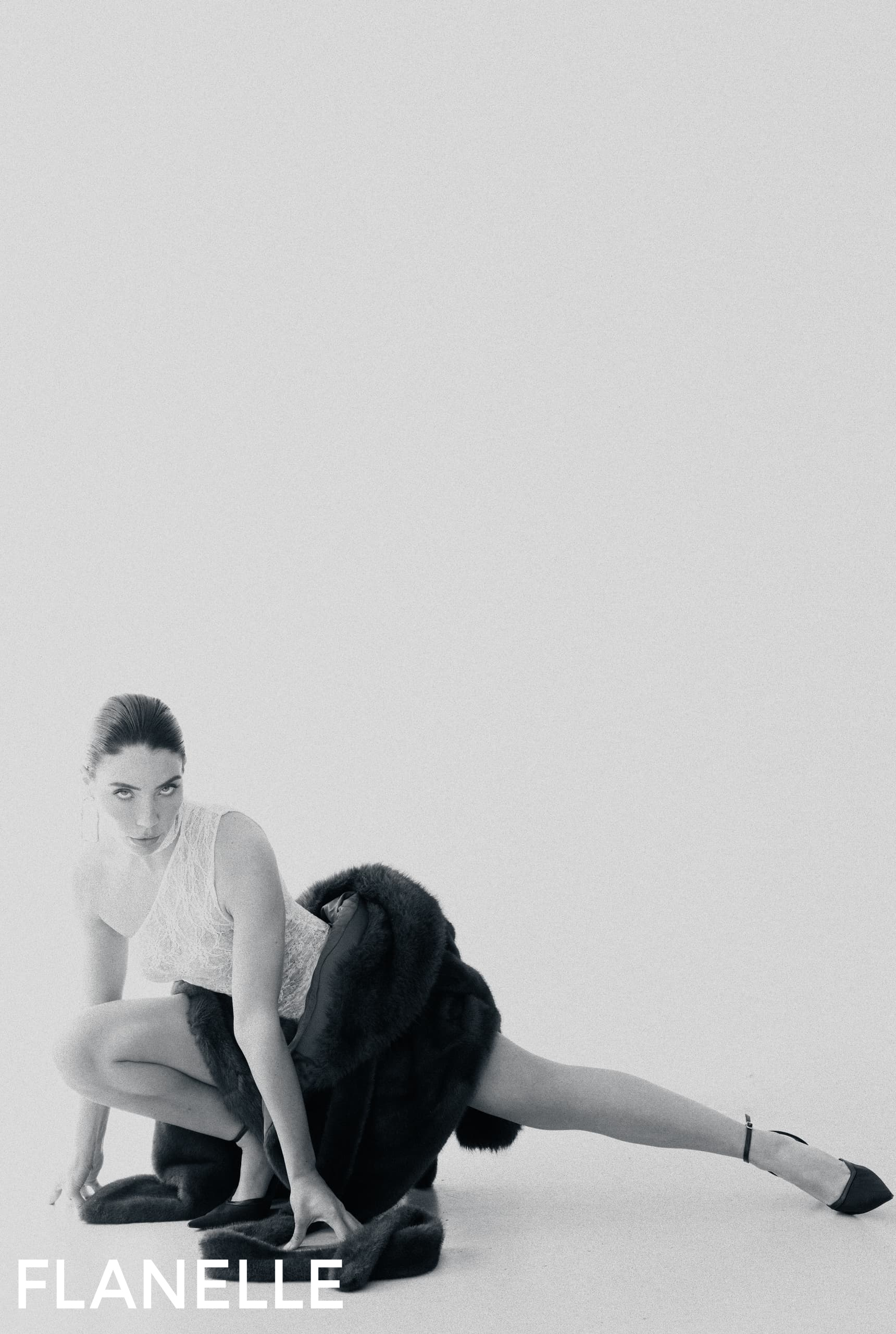 Fashion model in elegant pose, wearing lace and fur, for Flanelle magazine.