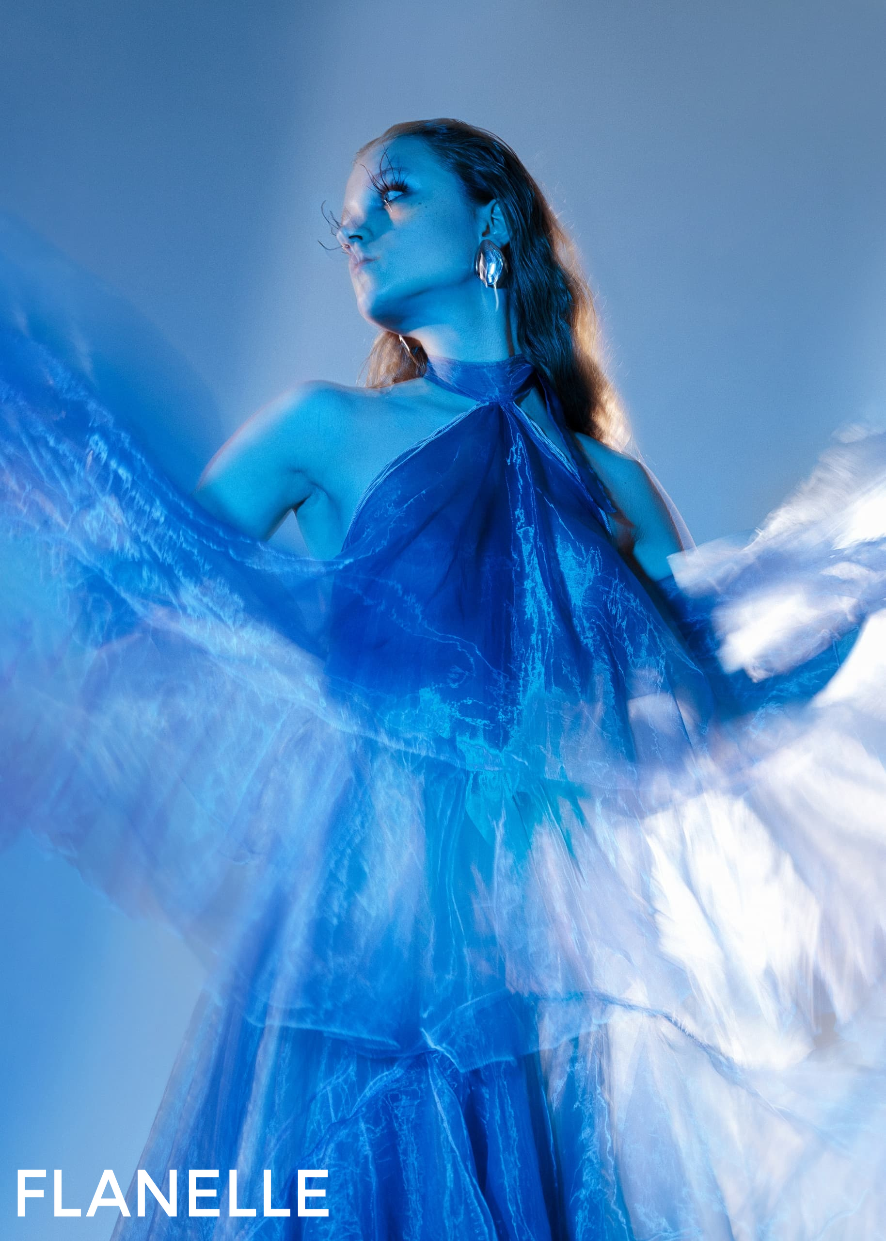 Blue ethereal dress, artistic pose, magazine style.