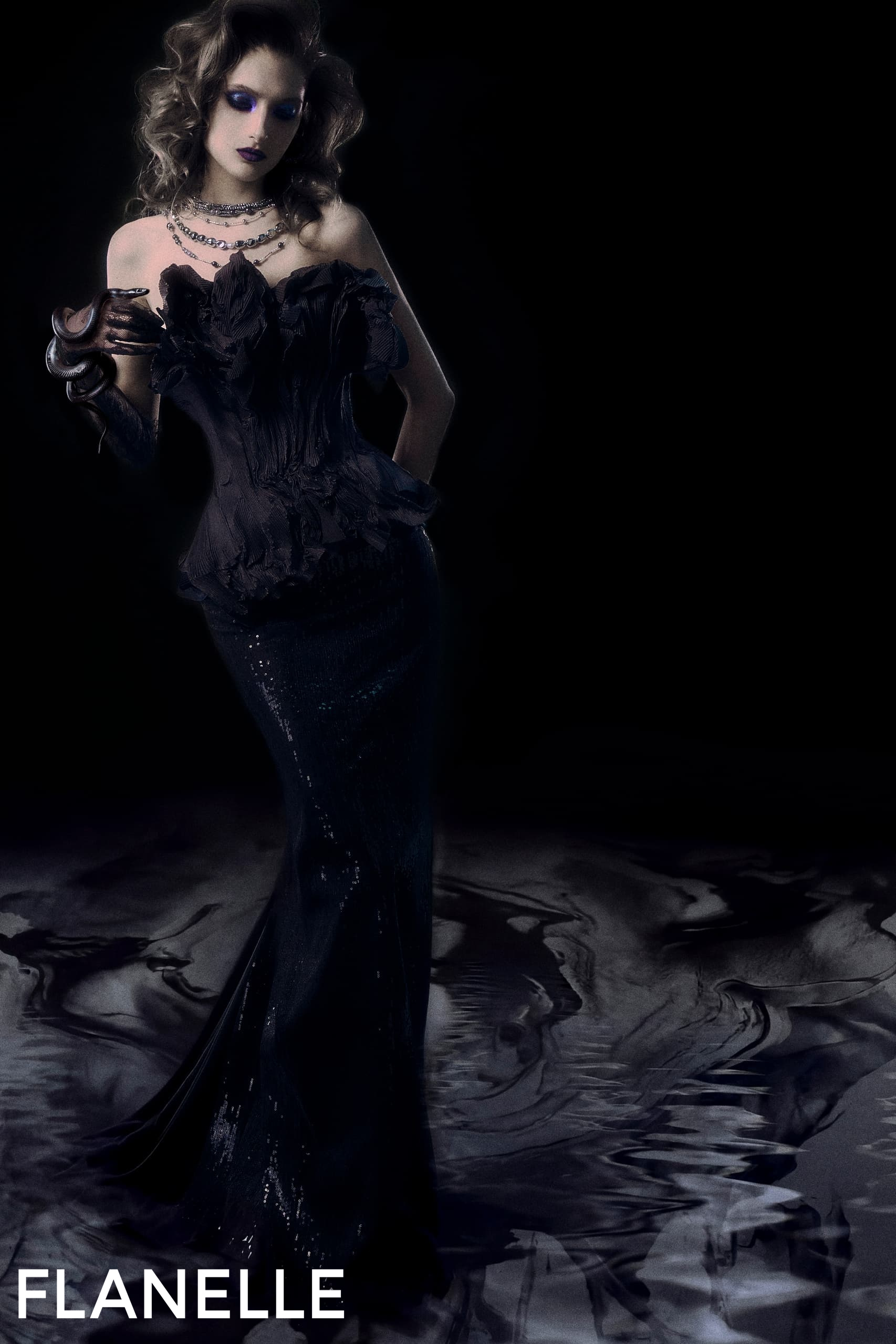 Elegant woman in dark gown holding snake, mysterious fashion photoshoot.