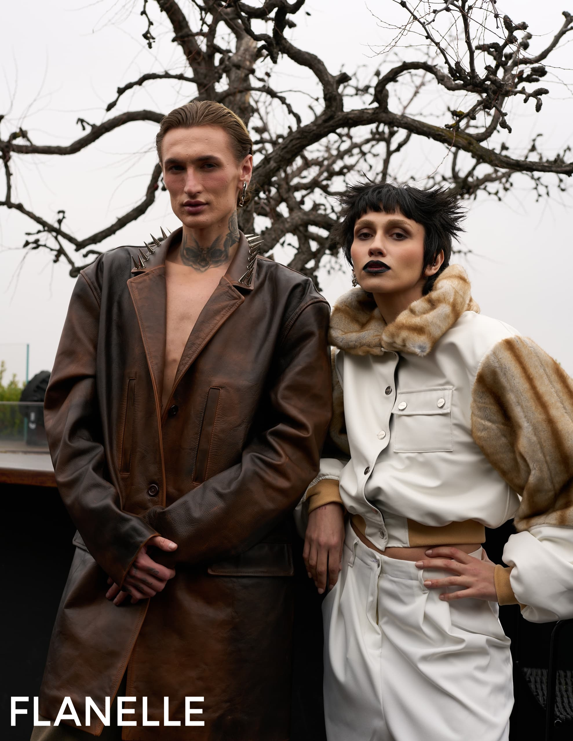 Fashion models in edgy leather and fur outfits outdoors.
