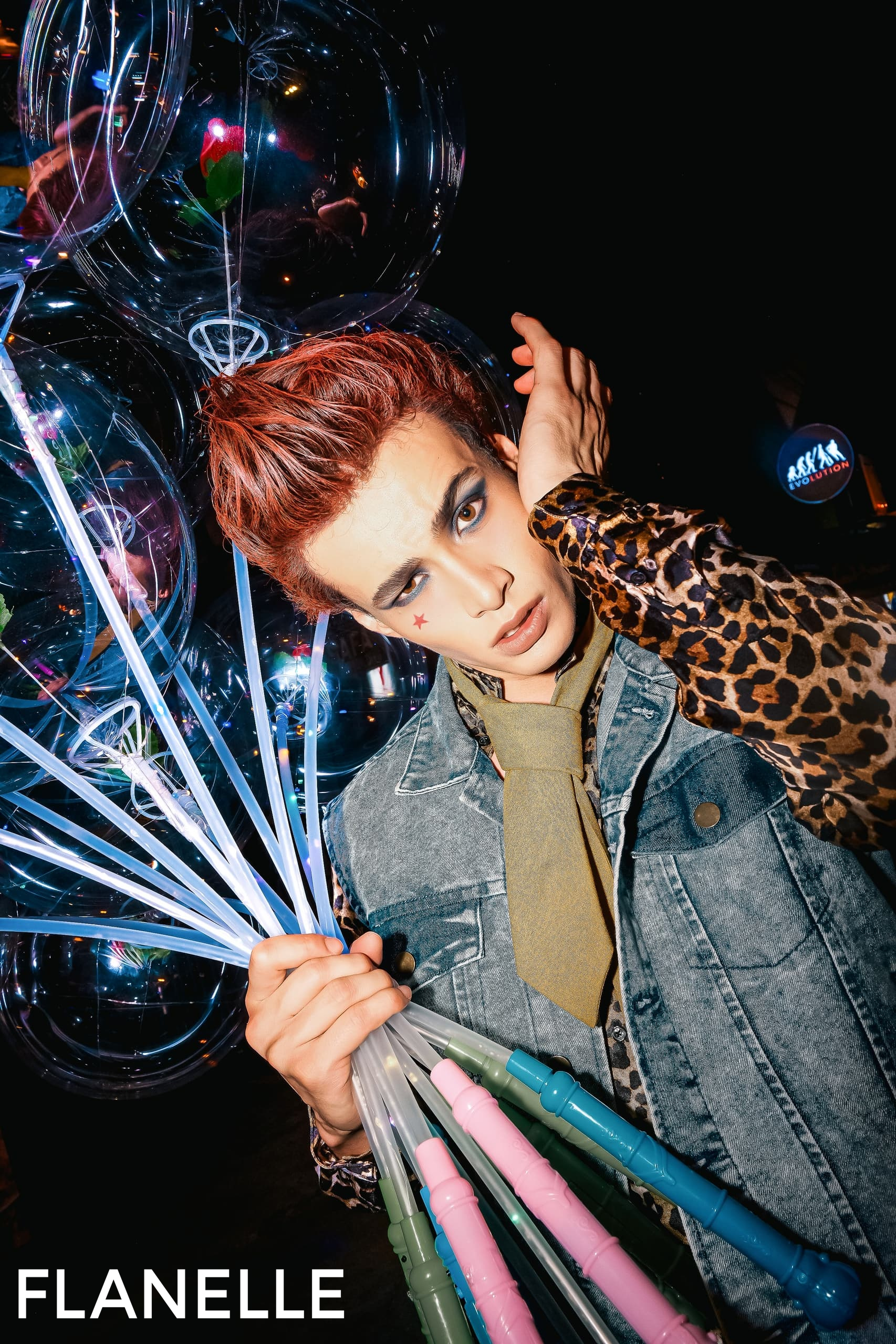 Fashionable person with LED balloons and unique outfit in a trendy nightlife setting.